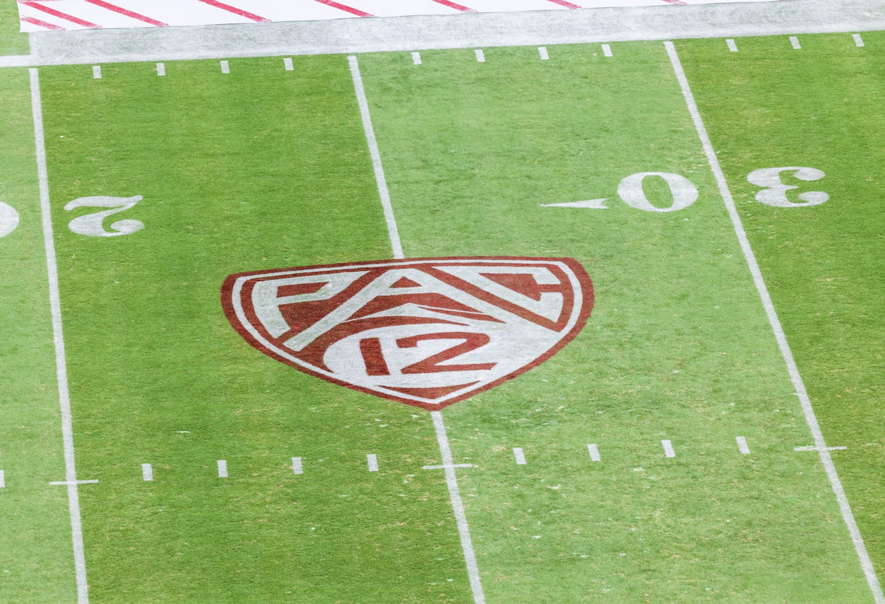 PALO ALTO, CA - SEPTEMBER 10:  A high angle view of the Pac-12 logo on the field of Stanford Stadium before a Pac-12 college football game between the USC Trojans and the Stanford Cardinal played on September 10, 2022 in Palo Alto, California.  (Photo by David Madison/Getty Images)
