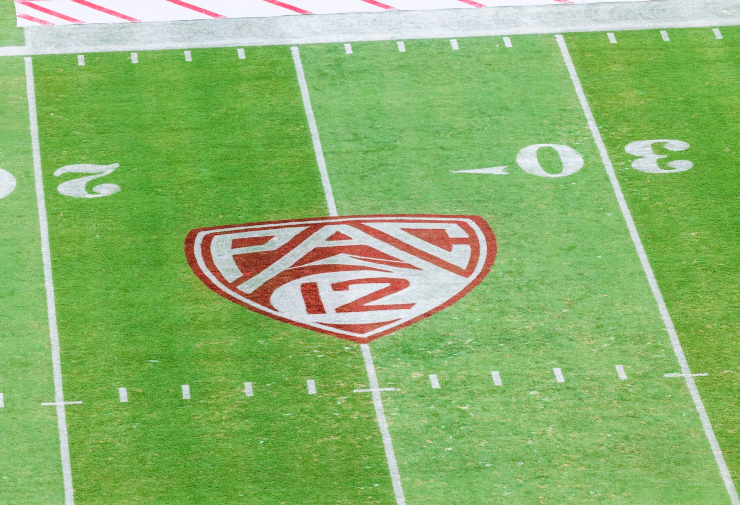 PALO ALTO, CA - SEPTEMBER 10:  A high angle view of the Pac-12 logo on the field of Stanford Stadium before a Pac-12 college football game between the USC Trojans and the Stanford Cardinal played on September 10, 2022 in Palo Alto, California.  (Photo by David Madison/Getty Images)