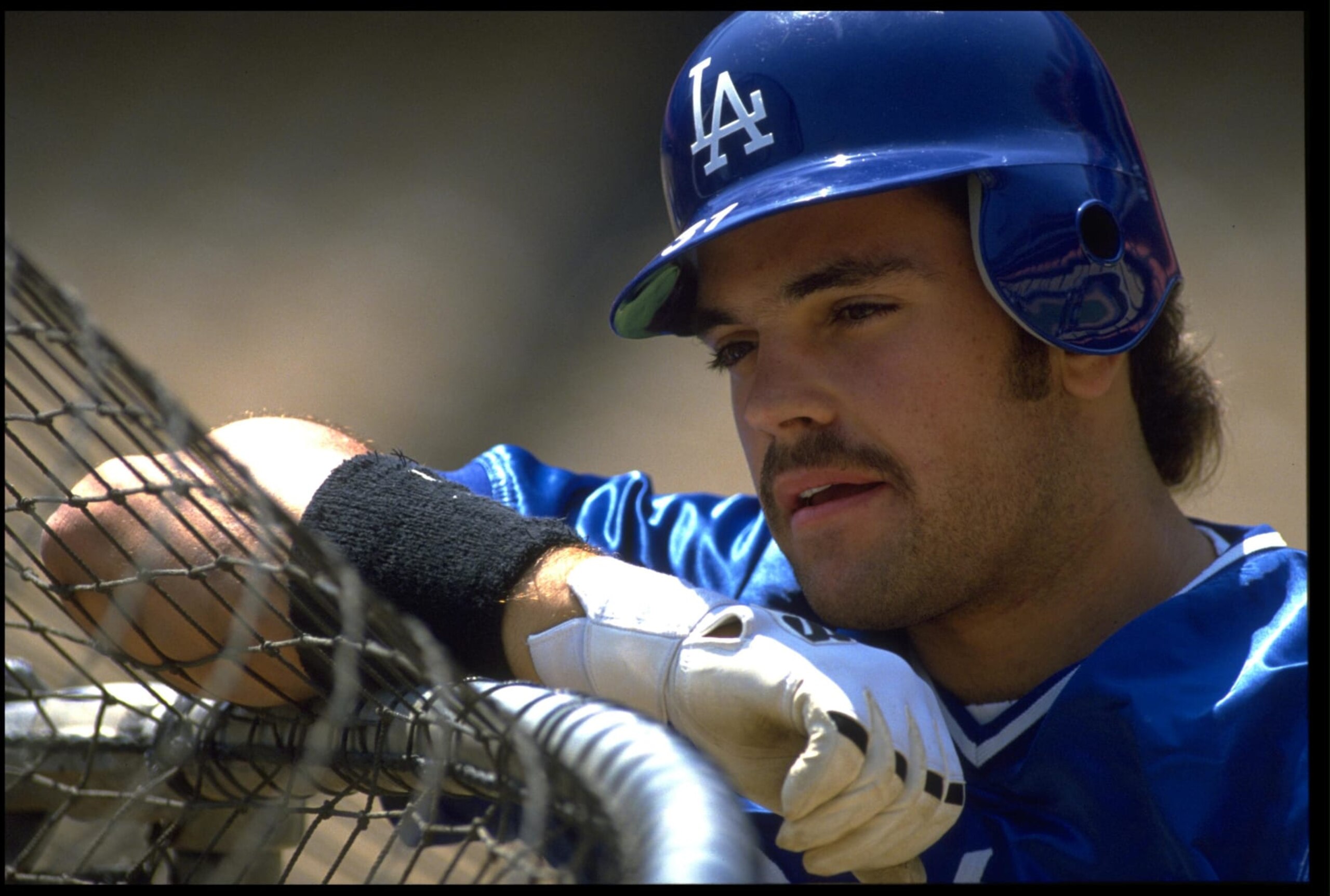 24 JUN 1993: MIKE PIAZZA, CATCHER FOR THE LOS ANGELES DODGERS, OBSERVES BATTING PRACTICE BEFORE THEIR GAME AGAINST THE HOUSTON ASTROS AT DODGER STADIUM IN LOS ANGELES, CALIFORNIA. MANDATORY CREDIT: JED JACOBSOHN/ALLSPORT. 24 JUN 1993: MIKE PIAZZA, CATCHER FOR THE LOS ANGELES DODGERS, OBSERVES BATTING PRACTICE BEFORE THEIR GAME AGAINST THE HOUSTON ASTROS AT DODGER STADIUM IN LOS ANGELES, CALIFORNIA. MANDATORY CREDIT: JED JACOBSOHN/ALLSPORT.