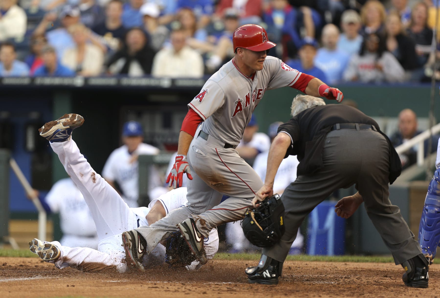 KANSAS CITY, MO - MAY 24:  Mike Trout #27 of the Los Angeles Angels of Anaheim crosses home past starting pitcher Luis Mendoza #39 of the Kansas City Royals as he scores on a wild pitch in the third inning at Kauffman Stadium on May 24, 2012 in Kansas City, Missouri. (Photo by Ed Zurga/Getty Images)