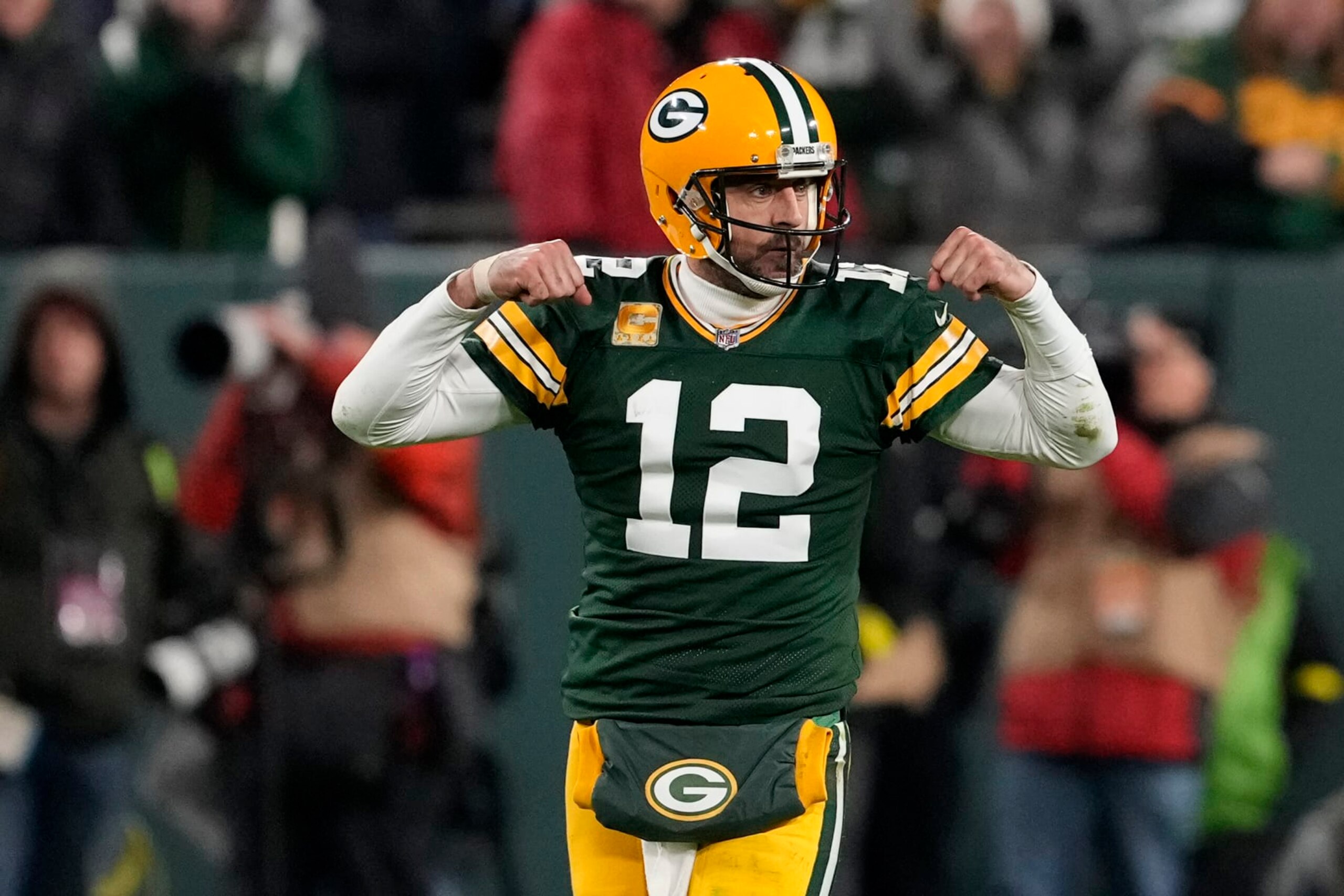GREEN BAY, WISCONSIN - NOVEMBER 13: Aaron Rodgers #12 of the Green Bay Packers celebrates after a play during overtime against the Dallas Cowboys at Lambeau Field on November 13, 2022 in Green Bay, Wisconsin. (Photo by Patrick McDermott/Getty Images)