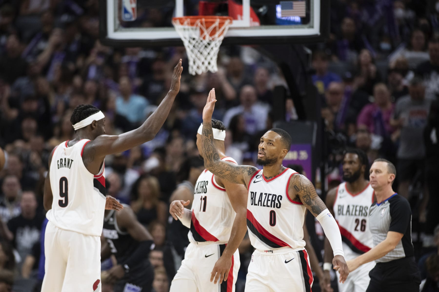 Portland Trail Blazers guard Damian Lillard (0) and forward Jerami Grant (9) celebrate late in the team's NBA basketball game against the Sacramento Kings in Sacramento, Calif., Wednesday, Oct. 19, 2022. The Trail Blazers won 115-108. (AP Photo/José Luis Villegas)