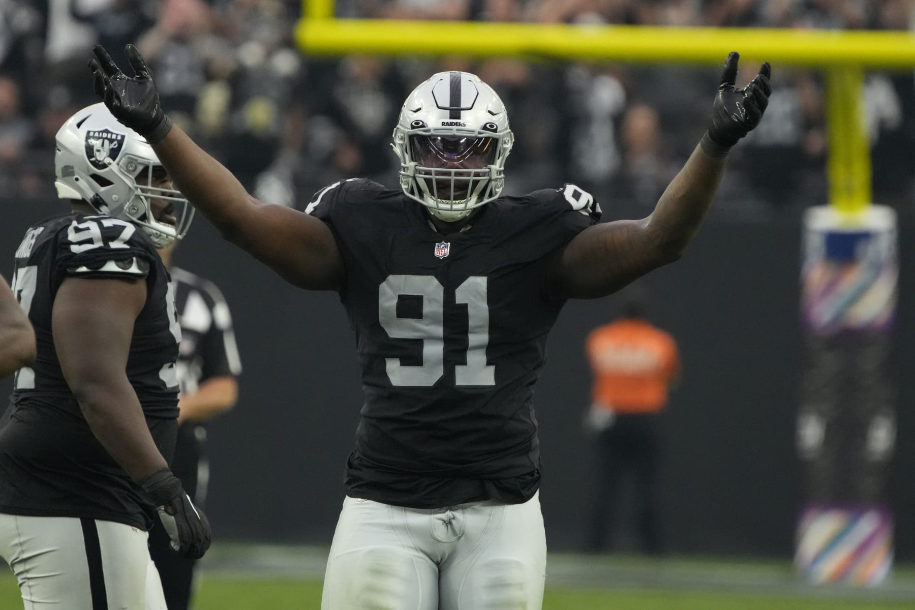 Las Vegas Raiders defensive tackle Bilal Nichols (91) yells to the fans during an NFL football game against the Houston Texans, Sunday, Oct 23, 2022, in Las Vegas. (AP Photo/Rick Scuteri)