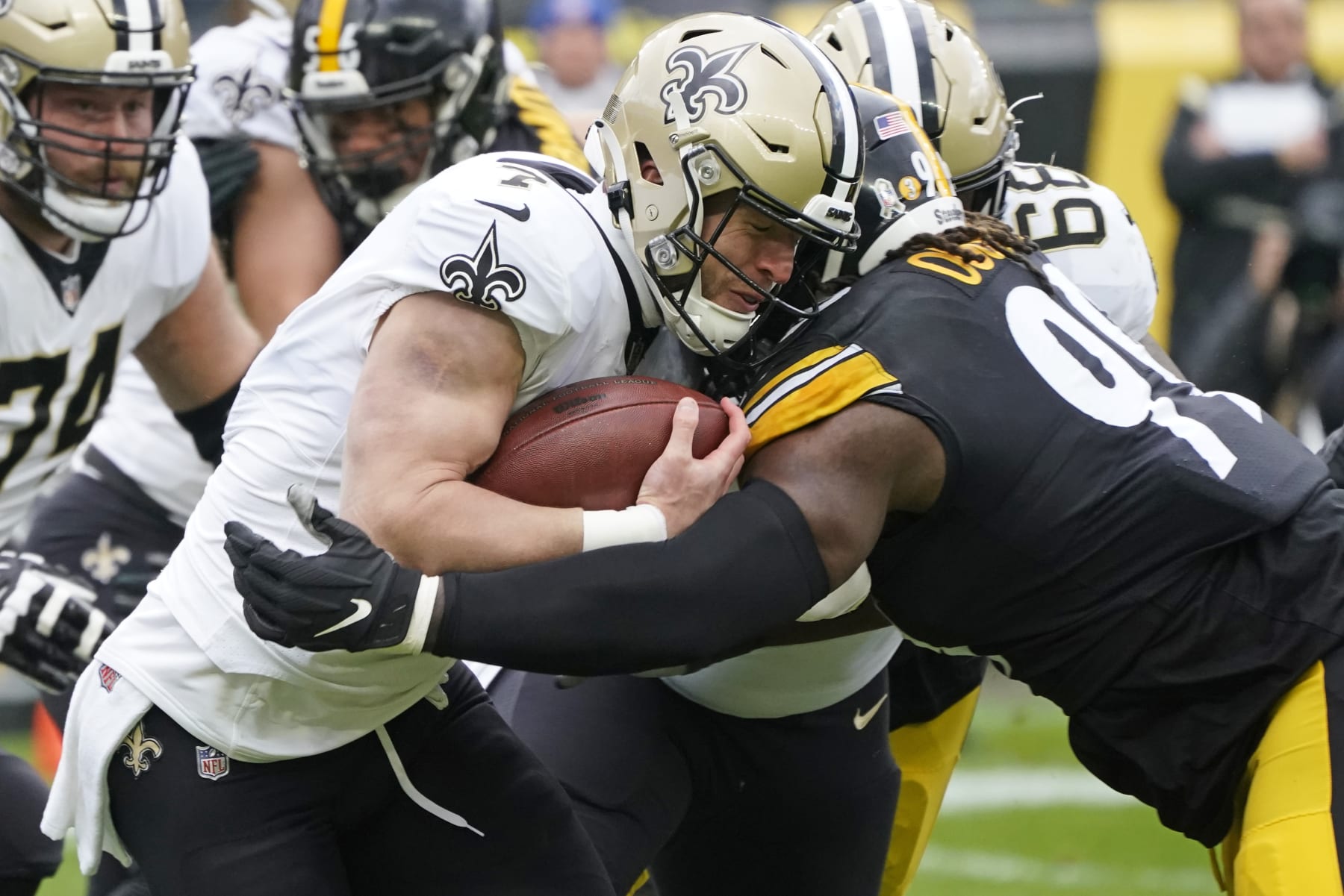 New Orleans Saints tight end Taysom Hill (7) is tackled by Pittsburgh Steelers defensive tackle Larry Ogunjobi (99) during the first half of an NFL football game in Pittsburgh, Sunday, Nov. 13, 2022. (AP Photo/Keith Srakocic)