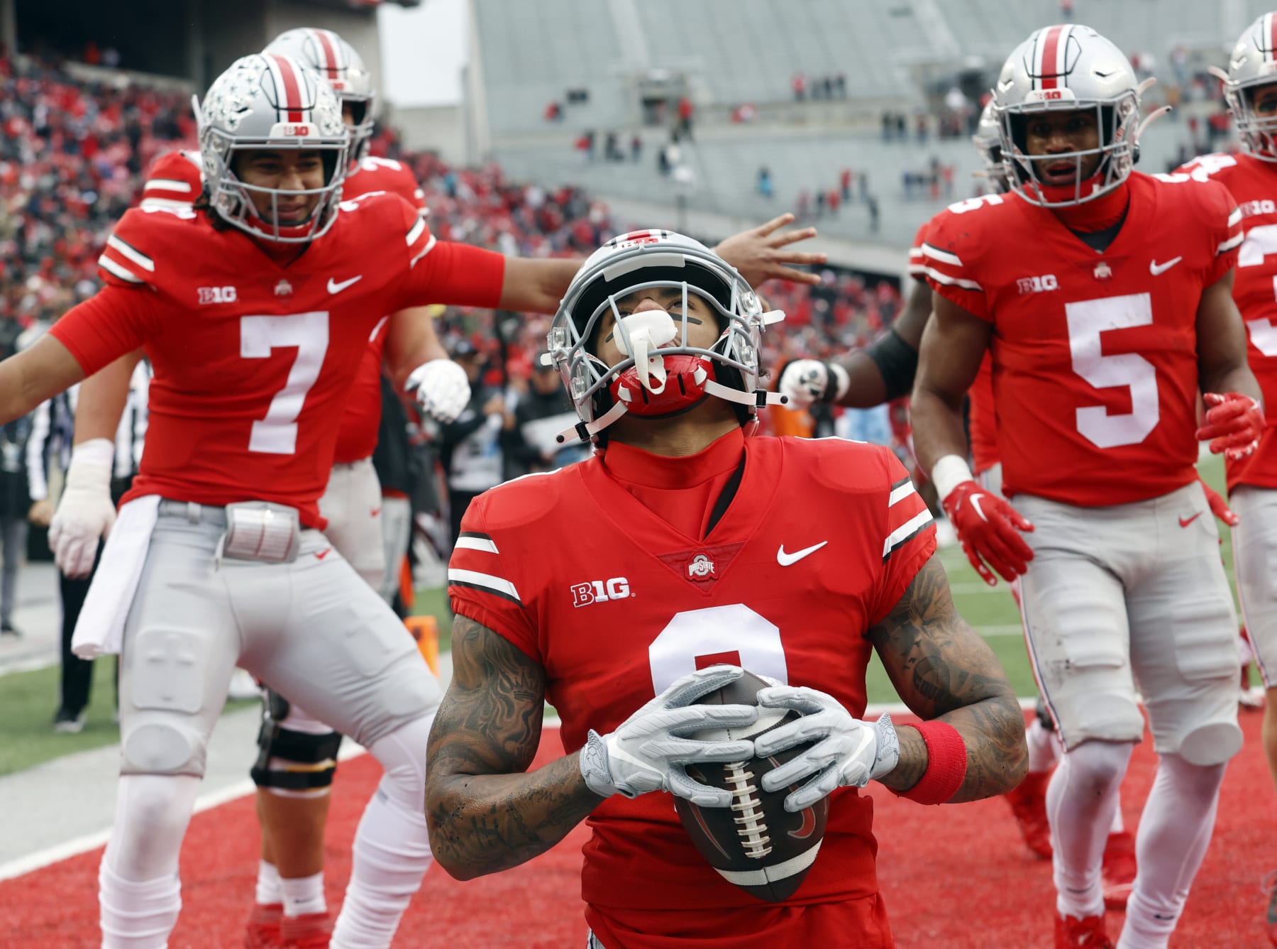 Ohio State wide receiver Kamryn Babb, center, celebrates his touchdown against Indiana with teammates quarterback C.J. Stroud, left, and running back Dallan Hayden during the second half of an NCAA college football game Saturday, Nov. 12, 2022 in Columbus, Ohio. Ohio State won 56-14. (AP Photo/Paul Vernon)