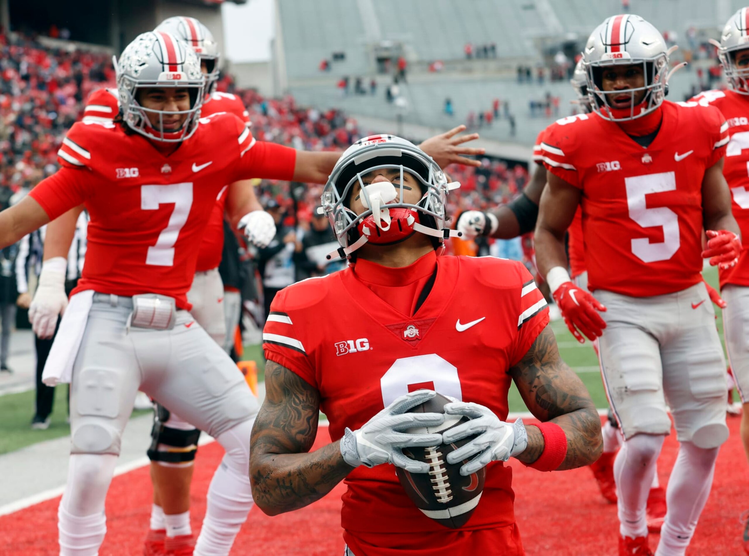 Ohio State wide receiver Kamryn Babb, center, celebrates his touchdown against Indiana with teammates quarterback C.J. Stroud, left, and running back Dallan Hayden during the second half of an NCAA college football game Saturday, Nov. 12, 2022 in Columbus, Ohio. Ohio State won 56-14. (AP Photo/Paul Vernon)