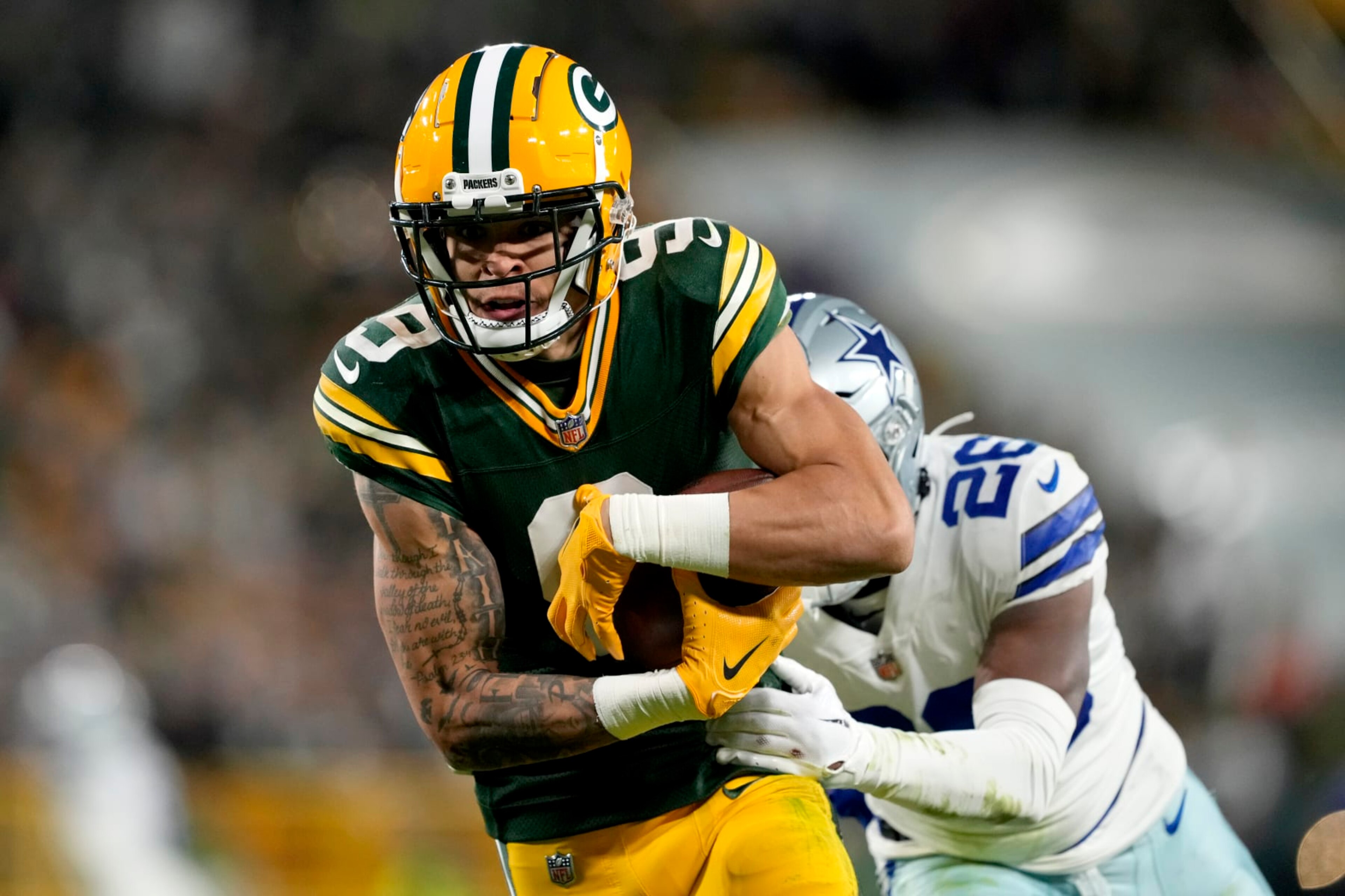 GREEN BAY, WISCONSIN - NOVEMBER 13: Christian Watson #9 of the Green Bay Packers catches a touchdown pass over DaRon Bland #26 of the Dallas Cowboys during the fourth quarter at Lambeau Field on November 13, 2022 in Green Bay, Wisconsin. (Photo by Patrick McDermott/Getty Images)