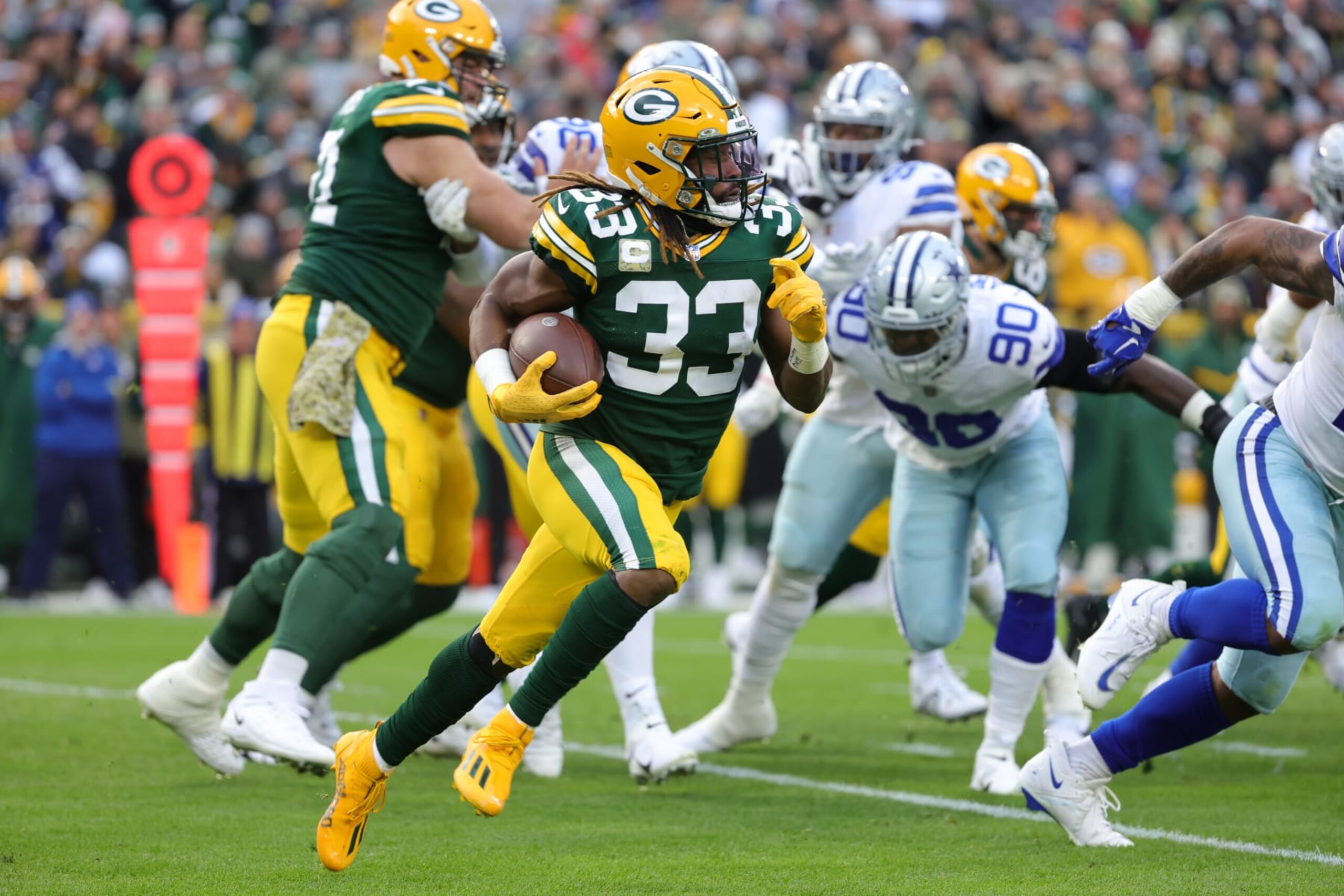 GREEN BAY, WISCONSIN - NOVEMBER 13: Aaron Jones #33 of the Green Bay Packers runs the ball during the first quarter against the Dallas Cowboys at Lambeau Field on November 13, 2022 in Green Bay, Wisconsin. (Photo by Stacy Revere/Getty Images) GREEN BAY, WISCONSIN - NOVEMBER 13: Aaron Jones #33 of the Green Bay Packers runs the ball during the first quarter against the Dallas Cowboys at Lambeau Field on November 13, 2022 in Green Bay, Wisconsin. (Photo by Stacy Revere/Getty Images)
