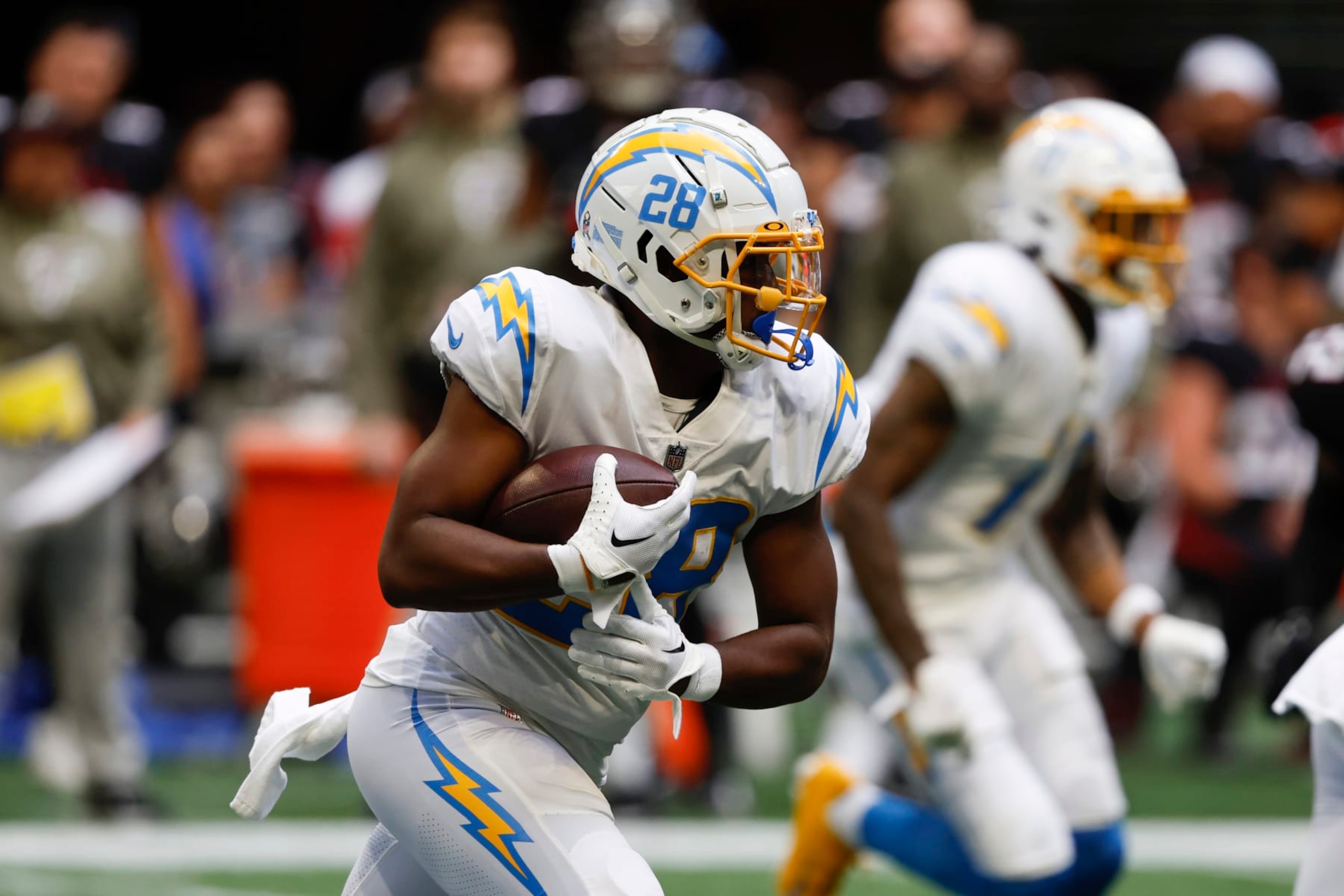 Los Angeles Chargers running back Isaiah Spiller (28) carries the ball up field during the second half of an NFL football game against the Atlanta Falcons, Sunday, Nov. 6, 2022, in Atlanta. (AP Photo/Butch Dill)