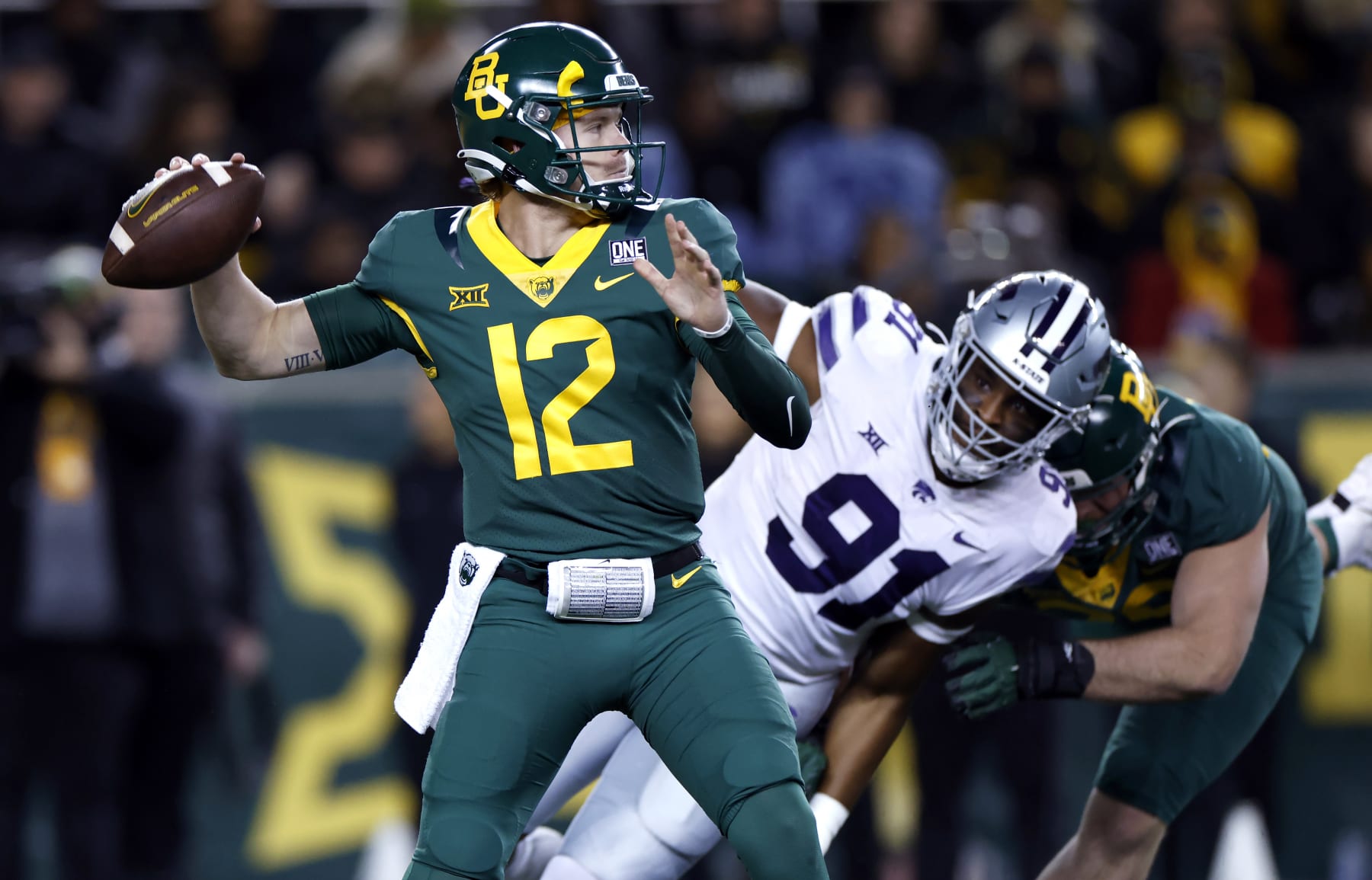 WACO, TX -NOVEMBER 12: Blake Shapen #12 of the Baylor Bears throws under pressure from Felix Anudike-Uzomah #91 of the Kansas State Wildcats in the first half of the game at McLane Stadium on November 12, 2022 in Waco, Texas. (Photo by Ron Jenkins/Getty Images)