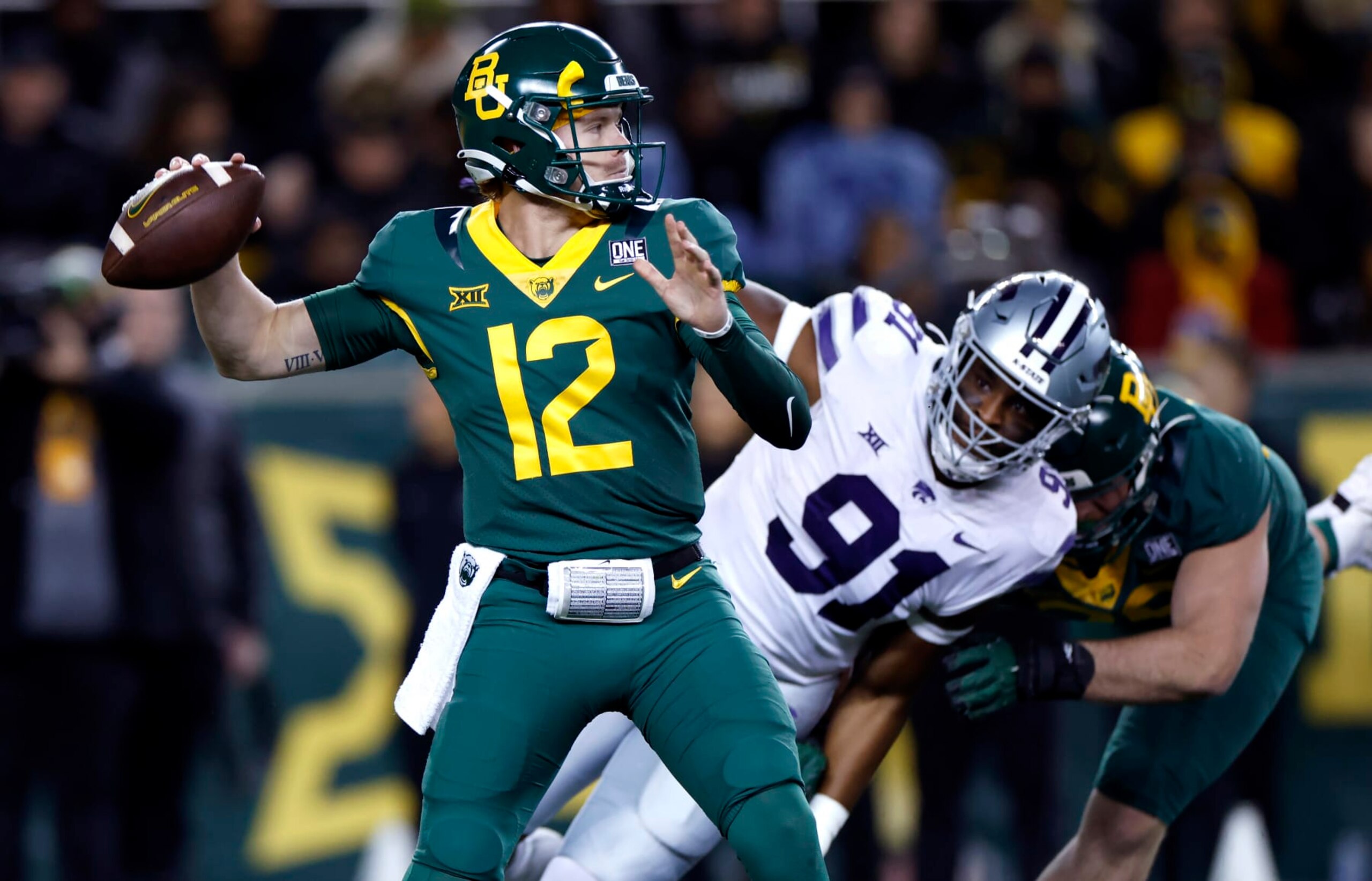 WACO, TX -NOVEMBER 12: Blake Shapen #12 of the Baylor Bears throws under pressure from Felix Anudike-Uzomah #91 of the Kansas State Wildcats in the first half of the game at McLane Stadium on November 12, 2022 in Waco, Texas. (Photo by Ron Jenkins/Getty Images)