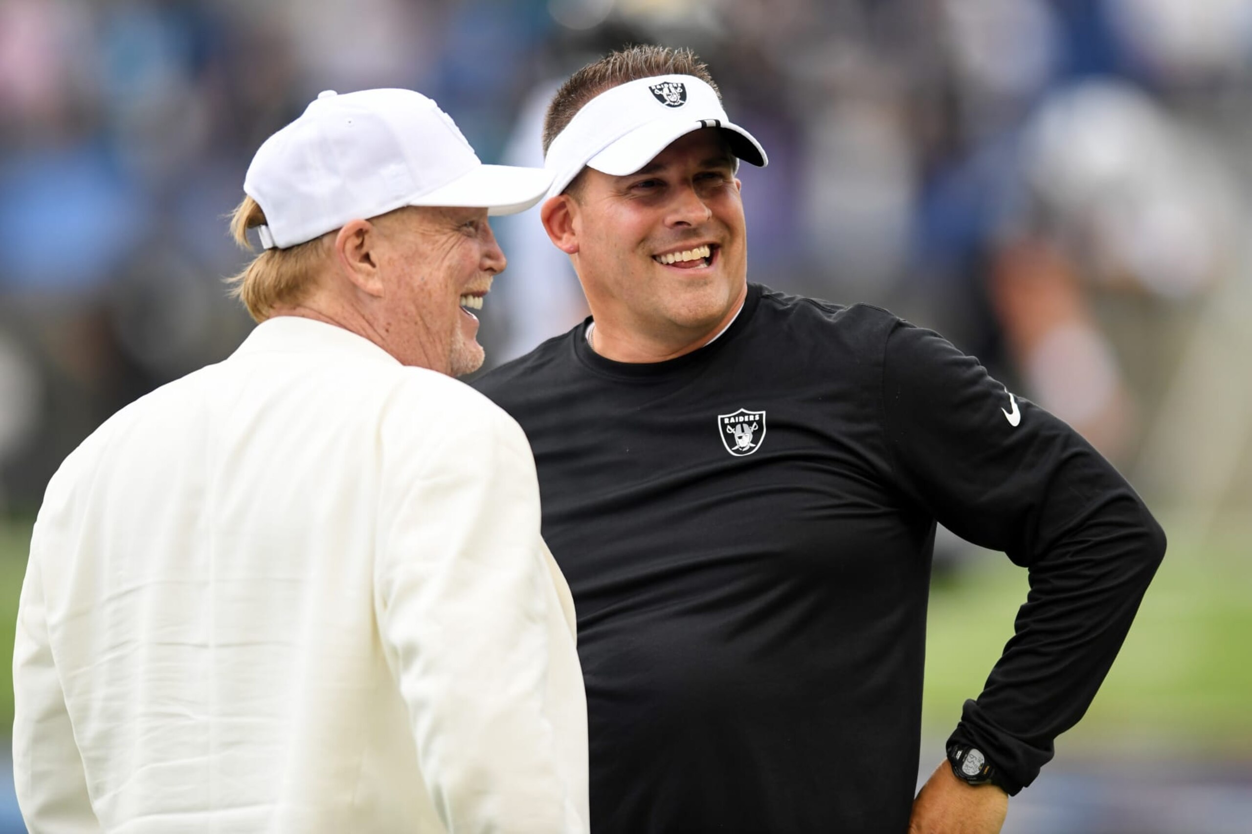 CANTON, OHIO - AUGUST 04: Head coach Josh McDaniels of the Las Vegas Raiders (R) talks with Raiders owner Mark Davis prior to the 2022 Pro Hall of Fame Game against the Jacksonville Jaguars at Tom Benson Hall Of Fame Stadium on August 04, 2022 in Canton, Ohio. (Photo by Nick Cammett/Getty Images)