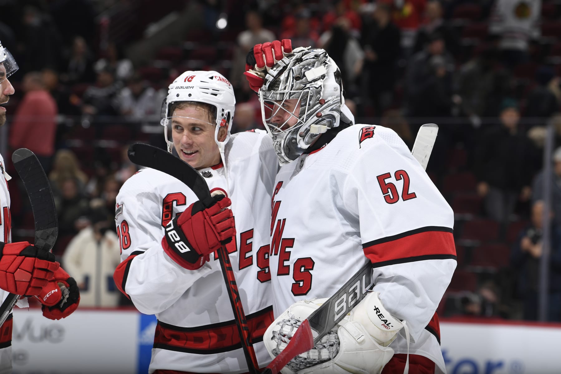 CHICAGO, ILLINOIS - NOVEMBER 14: Goalie Pyotr Kochetkov #52 and Jack Drury #18 of the Carolina Hurricanes celebrate after Kochetkov made 27 saves for his first career shutout. The Carolina Hurricanes beat the Chicago Blackhawks 3-0 at United Center on November 14, 2022 in Chicago, Illinois. (Photo by Bill Smith/NHLI via Getty Images)