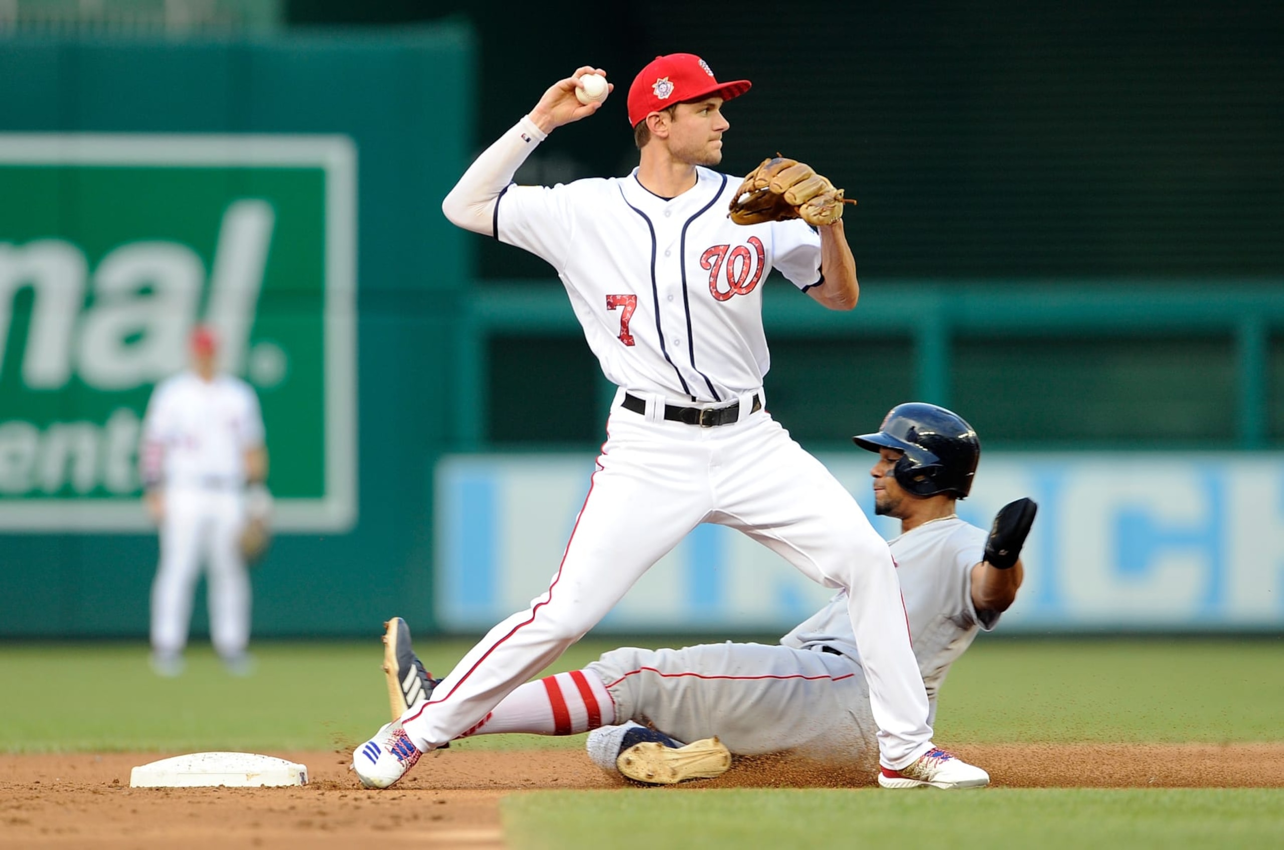 WASHINGTON, DC - JULY 03:  Xander Bogaerts #2 of the Boston Red Sox is forced out at second base in the second inning by Trea Turner #7 of the Washington Nationals at Nationals Park on July 3, 2018 in Washington, DC.  (Photo by Greg Fiume/Getty Images)