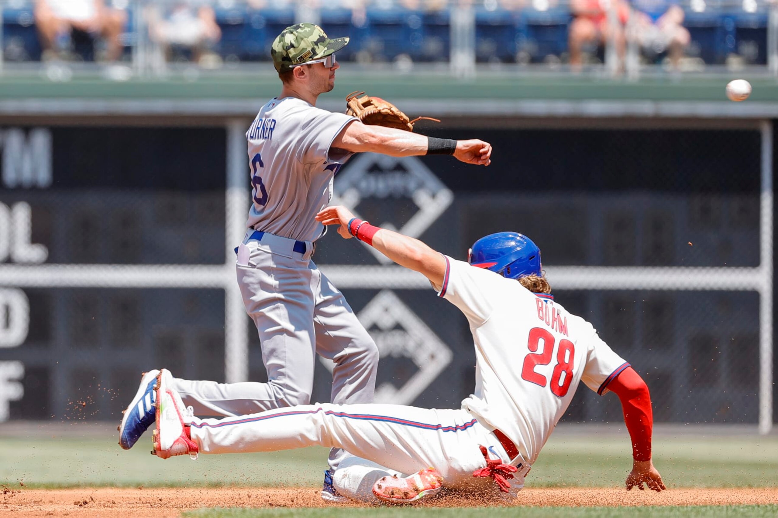 PHILADELPHIA, PENNSYLVANIA - MAY 22: Trea Turner #6 of the Los Angeles Dodgers forces out Alec Bohm #28 of the Philadelphia Phillies at second base during the first inning at Citizens Bank Park on May 22, 2022 in Philadelphia, Pennsylvania. (Photo by Tim Nwachukwu/Getty Images)