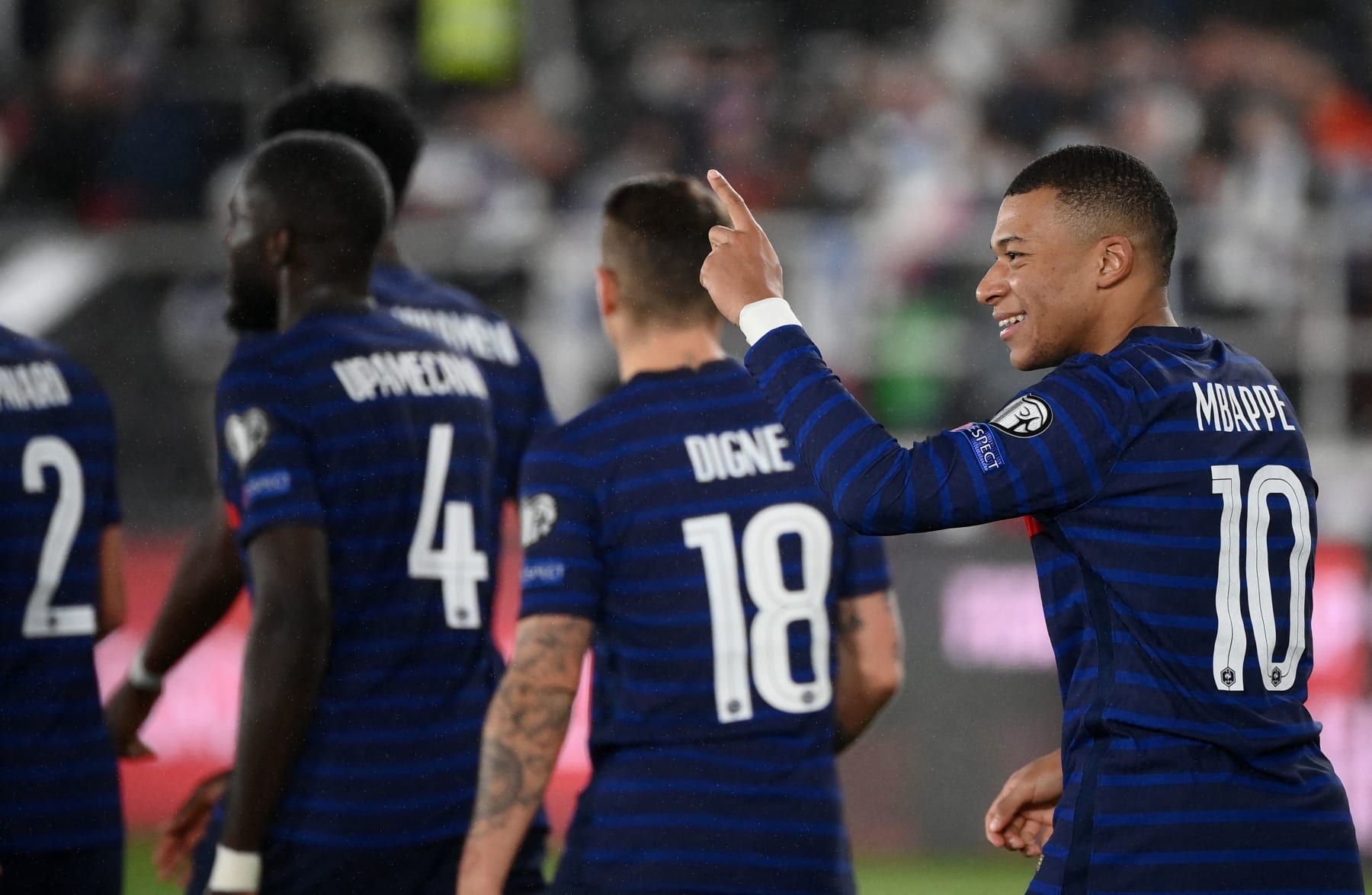 France's forward Kylian Mbappe (R) celebrates scoring his team's second goal during the FIFA World Cup Qatar 2022 qualification Group D football match between Finland and France at the Olympic Stadium in Helsinki, on November 16, 2021. (Photo by FRANCK FIFE / AFP) (Photo by FRANCK FIFE/AFP via Getty Images)