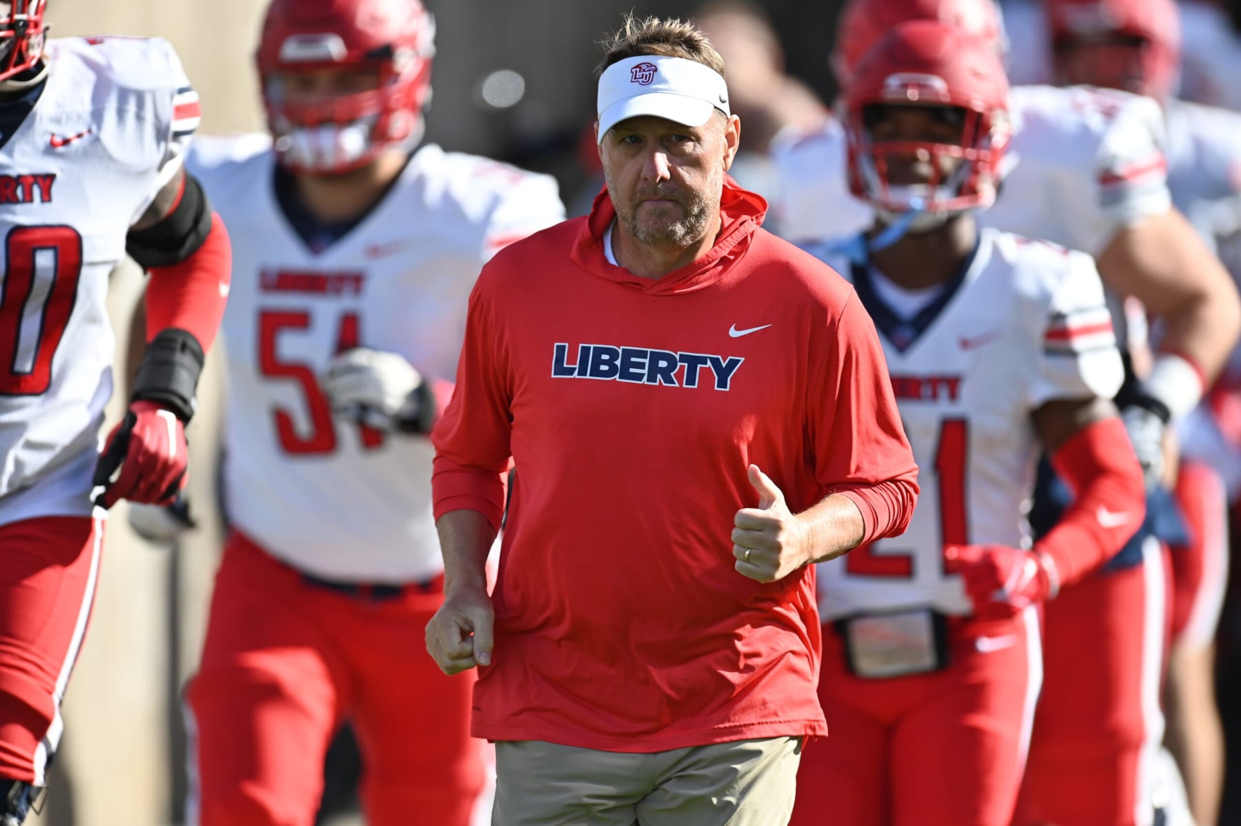 EAST HARTFORD, CT - NOVEMBER 12: Liberty Flames head coach Hugh Freeze leads the team out onto the field prior to the start of the game as the Liberty Flames take on the UConn Huskies on November 12, 2022, at the Rentschler Field in East Hartford, Connecticut. (Photo by Williams Paul/Icon Sportswire via Getty Images)