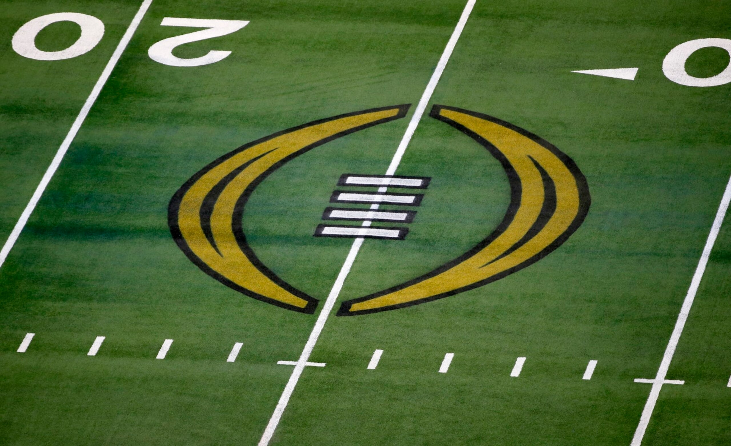 FILE - The College Football Playoff logo is shown on the field at AT&T Stadium before the Rose Bowl NCAA college football game between Notre Dame and Alabama in Arlington, Texas, Jan. 1, 2021. The most positive development at the latest meeting on expanding the College Football Playoff was that the people involved agreed to keep talking. There is no firm date for the next meeting, but there is one regularly schedule for January around the College Football Playoff championship game. (AP Photo/Roger Steinman, File)