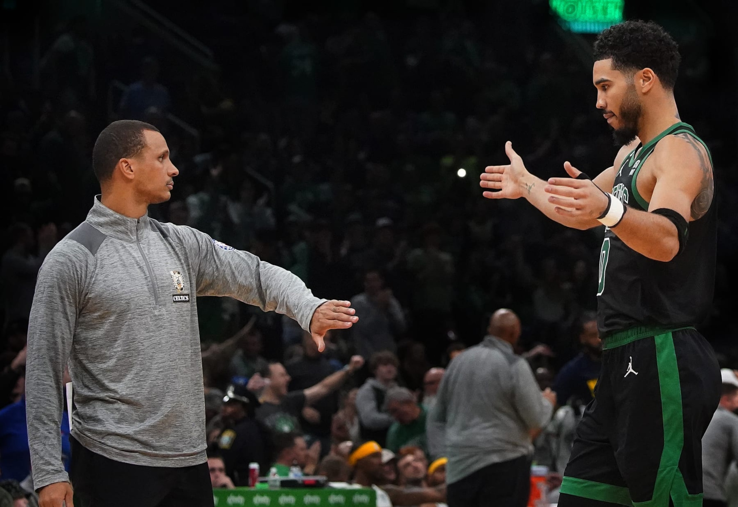Boston, MA - November 11: Boston Celtics SF Jayson Tatum goes in to hug interim head coach Joe Mazzulla late in the fourth quarter. The Celtics beat the Denver Nuggets, 131-112. (Photo by Barry Chin/The Boston Globe via Getty Images)