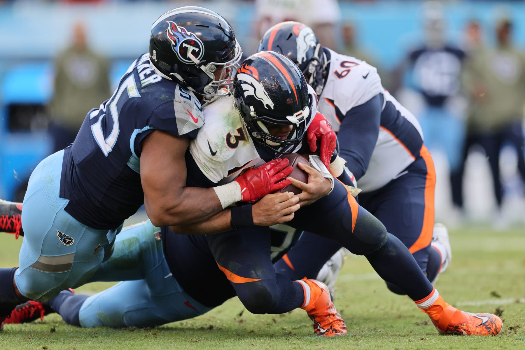 NASHVILLE, TENNESSEE - NOVEMBER 13: DeMarcus Walker #95 of the Tennessee Titans sacks Russell Wilson #3 of the Denver Broncos during the fourth quarter at Nissan Stadium on November 13, 2022 in Nashville, Tennessee. (Photo by Andy Lyons/Getty Images)