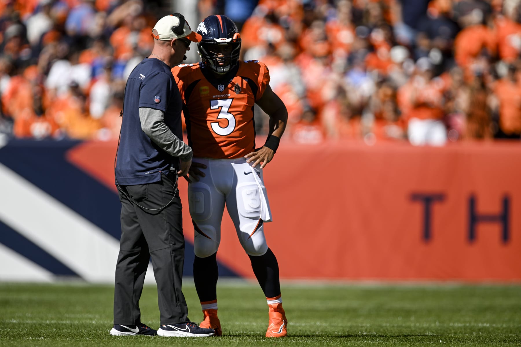 DENVER, CO - SEPTEMBER 18: Head coach Nathaniel Hackett of the Denver Broncos speaks to Russell Wilson (3) on the field during the first quarter against the Houston Texans at Empower Field at Mile High in Denver on Sunday, September 18, 2022. (Photo by AAron Ontiveroz/MediaNews Group/The Denver Post via Getty Images)