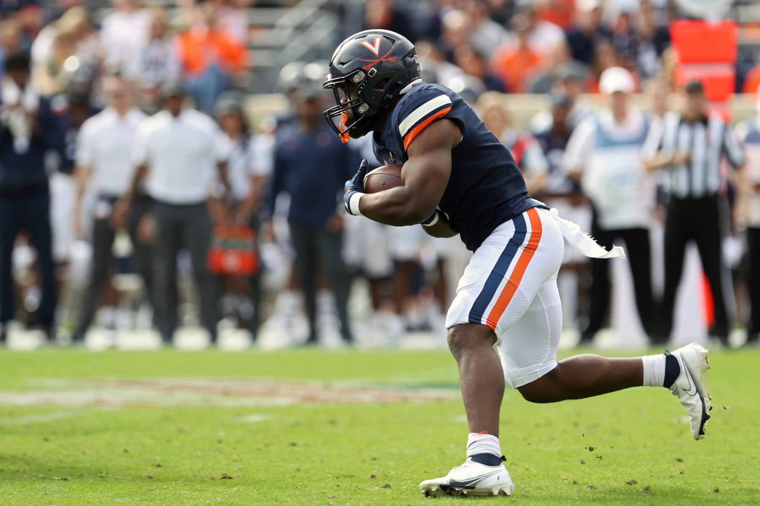 CHARLOTTESVILLE, VA - NOVEMBER 12: Mike Hollins #7 of the Virginia Cavaliers rushes in the first half during a game against the Pittsburgh Panthers at Scott Stadium on November 12, 2022 in Charlottesville, Virginia. (Photo by Ryan M. Kelly/Getty Images)