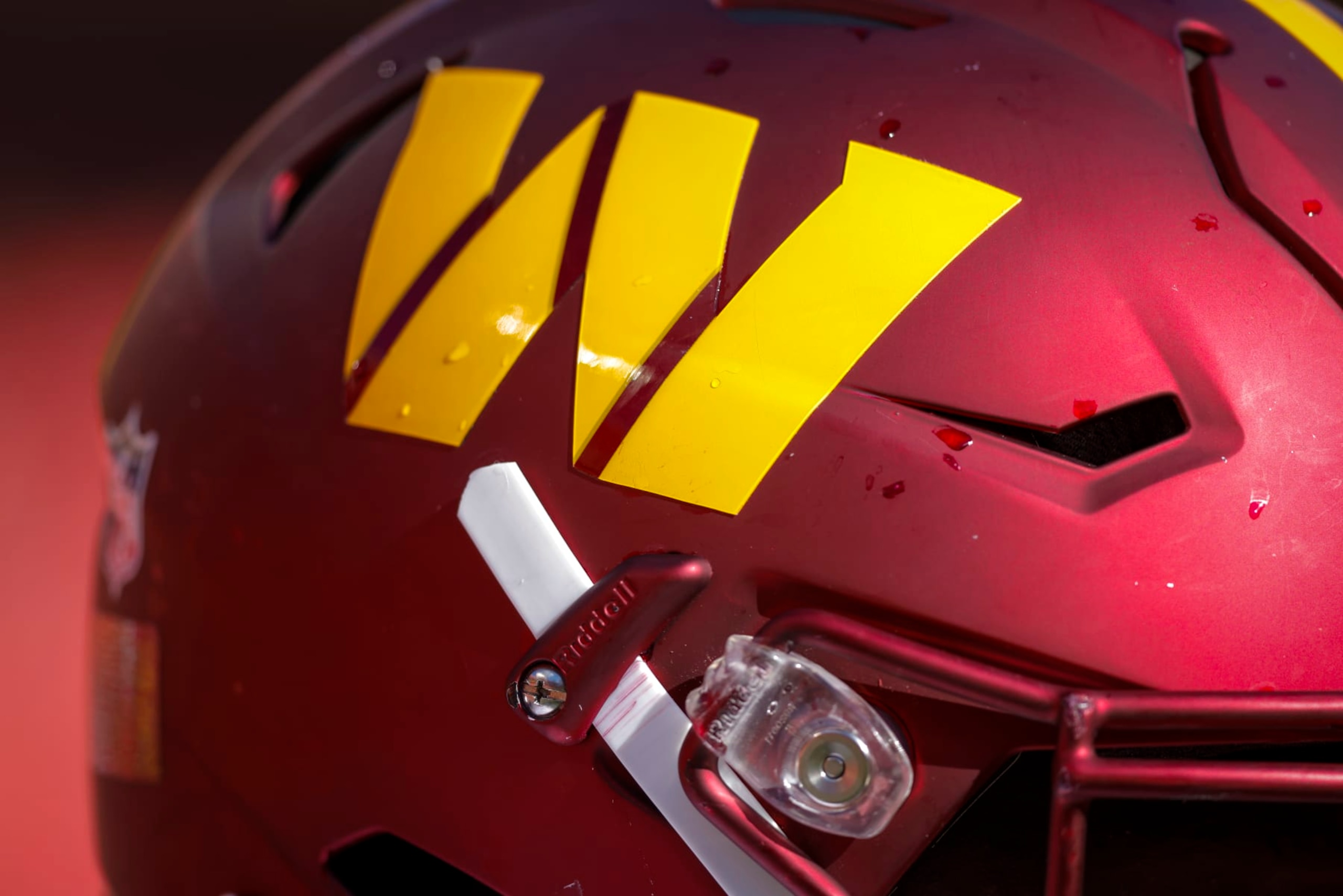 KANSAS CITY, MO - AUGUST 20: The gold Washington Commanders helmet logo on the burgundy helmet, worn by Willie Beavers #64 of the Washington Commanders during the preseason game against the Kansas City Chiefs at Arrowhead Stadium on August 20, 2022 in Kansas City, Missouri. (Photo by David Eulitt/Getty Images) KANSAS CITY, MO - AUGUST 20: The gold Washington Commanders helmet logo on the burgundy helmet, worn by Willie Beavers #64 of the Washington Commanders during the preseason game against the Kansas City Chiefs at Arrowhead Stadium on August 20, 2022 in Kansas City, Missouri. (Photo by David Eulitt/Getty Images)