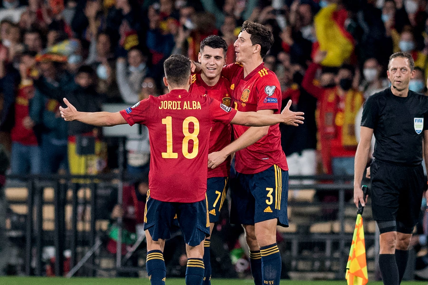 Spain's forward Alvaro Morata (C) celebrates with teammates after scoring his team's first goal during the FIFA World Cup Qatar 2022 qualification group B football match between Spain and Sweden, at La Cartuja Stadium in Seville, on November 14, 2021. (Photo by JORGE GUERRERO / AFP) (Photo by JORGE GUERRERO/AFP via Getty Images)