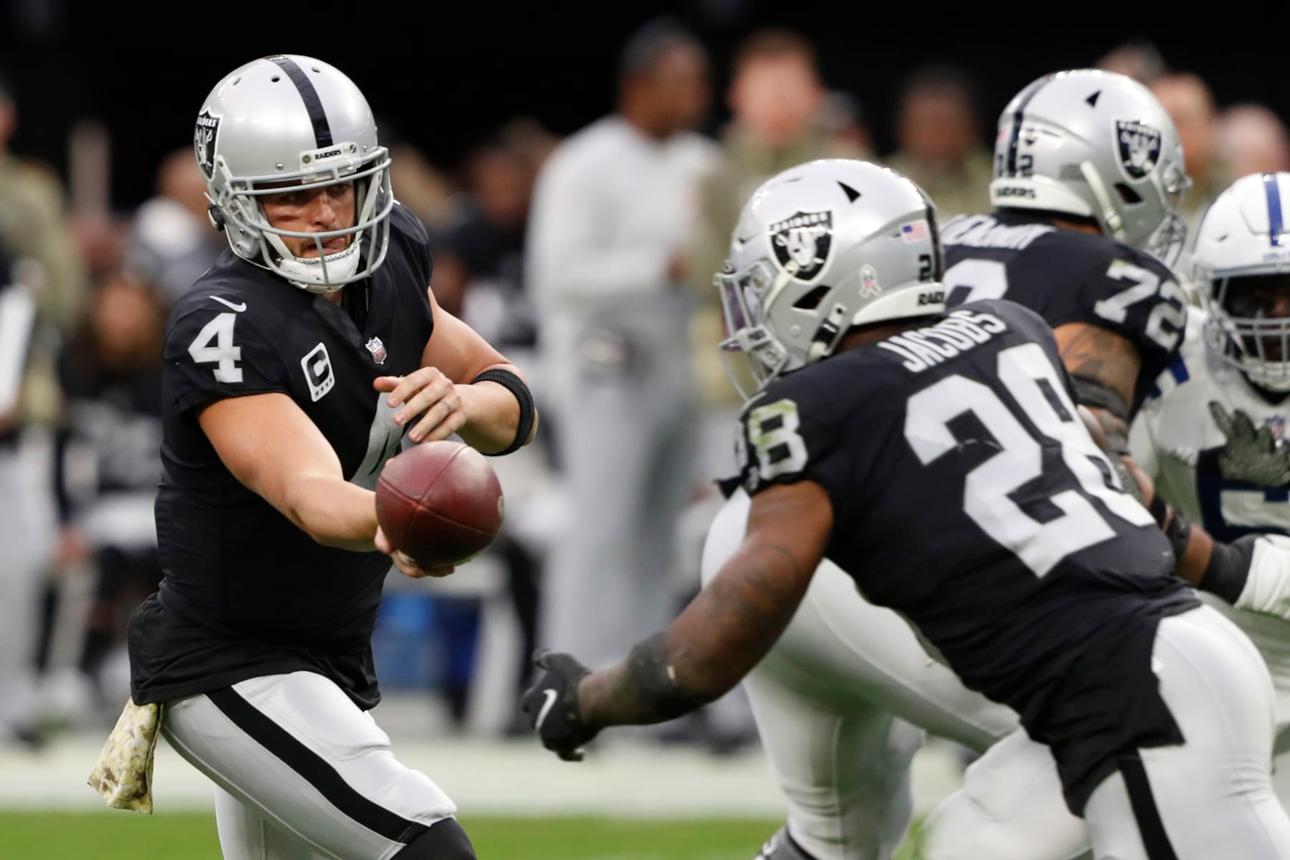 LAS VEGAS, NEVADA - NOVEMBER 13: Derek Carr #4 of the Las Vegas Raiders hands the ball off to Josh Jacobs #28 during the second quarter of the game against the Indianapolis Colts at Allegiant Stadium on November 13, 2022 in Las Vegas, Nevada. (Photo by Steve Marcus/Getty Images) LAS VEGAS, NEVADA - NOVEMBER 13: Derek Carr #4 of the Las Vegas Raiders hands the ball off to Josh Jacobs #28 during the second quarter of the game against the Indianapolis Colts at Allegiant Stadium on November 13, 2022 in Las Vegas, Nevada. (Photo by Steve Marcus/Getty Images)