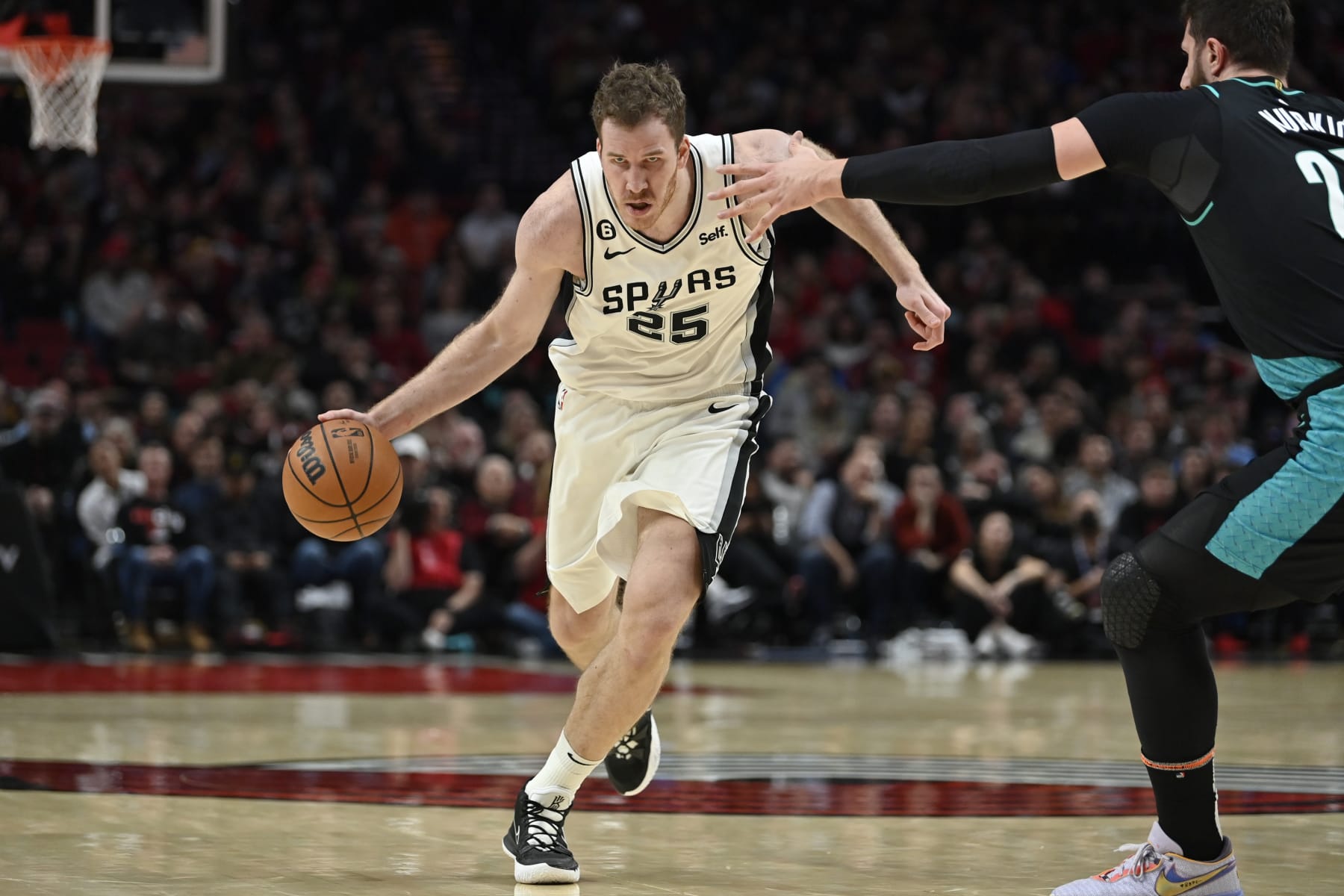 PORTLAND, OREGON - NOVEMBER 15: Jakob Poeltl #25 of the San Antonio Spurs drives during the fourth quarter against the Portland Trail Blazers at the Moda Center on November 15, 2022 in Portland, Oregon. The Portland Trail Blazers won 117-110. NOTE TO USER: User expressly acknowledges and agrees that, by downloading and or using this photograph, User is consenting to the terms and conditions of the Getty Images License Agreement. (Photo by Alika Jenner/Getty Images)