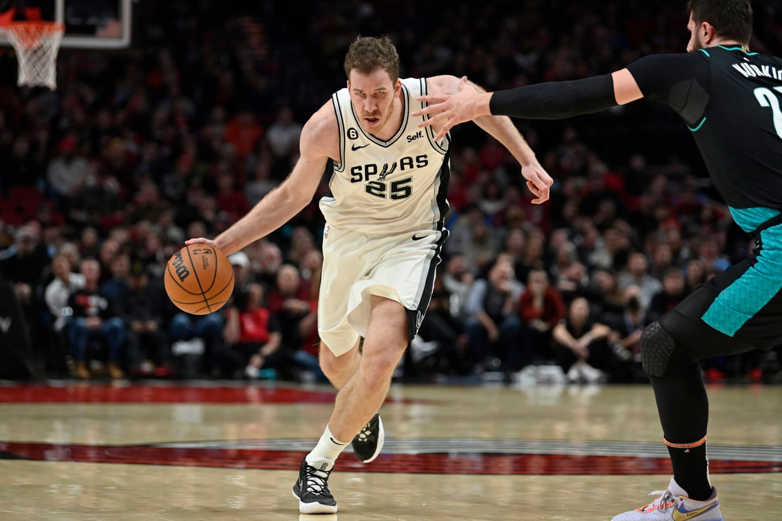 PORTLAND, OREGON - NOVEMBER 15: Jakob Poeltl #25 of the San Antonio Spurs drives during the fourth quarter against the Portland Trail Blazers at the Moda Center on November 15, 2022 in Portland, Oregon. The Portland Trail Blazers won 117-110. NOTE TO USER: User expressly acknowledges and agrees that, by downloading and or using this photograph, User is consenting to the terms and conditions of the Getty Images License Agreement. (Photo by Alika Jenner/Getty Images)