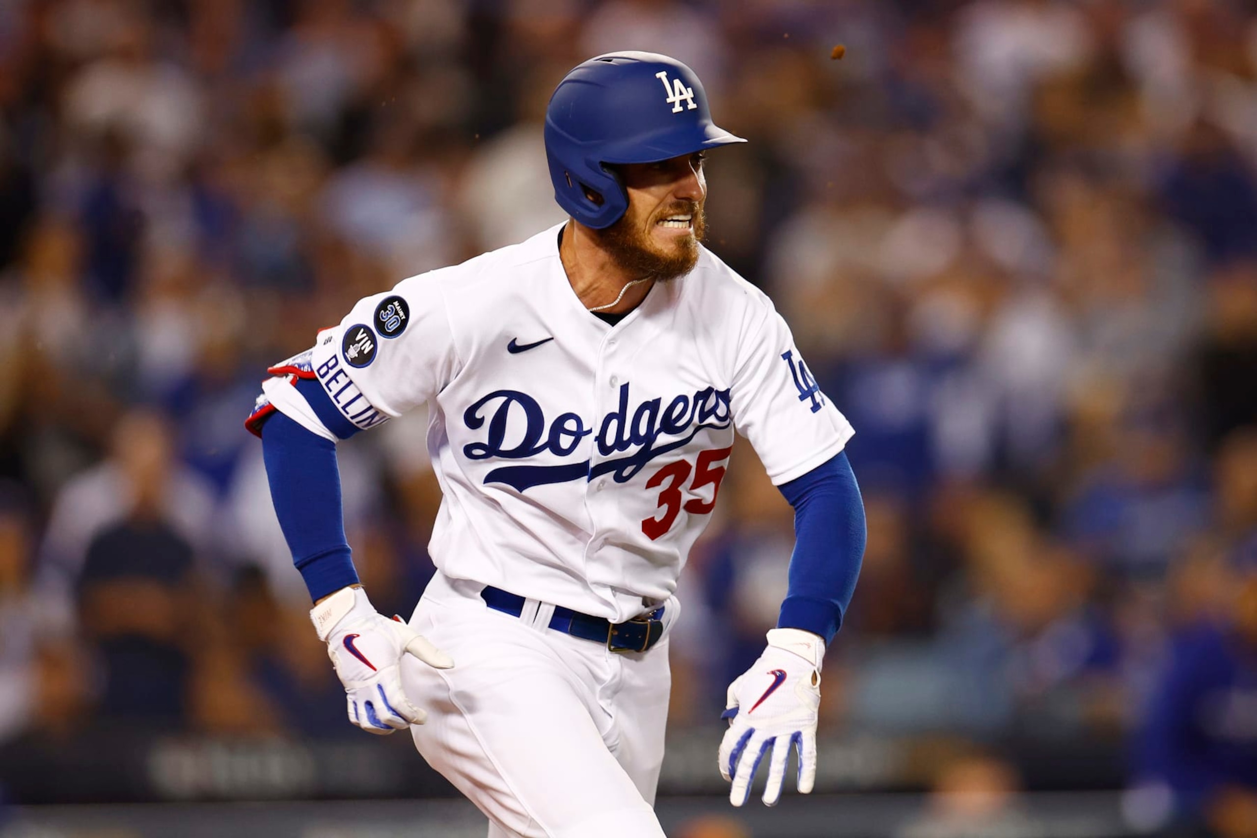 LOS ANGELES, CALIFORNIA - OCTOBER 11: Cody Bellinger #35 of the Los Angeles Dodgers reaches first base on a fielding error by the San Diego Padres during the third inning in game one of the National League Division Series at Dodger Stadium on October 11, 2022 in Los Angeles, California. (Photo by Ronald Martinez/Getty Images)