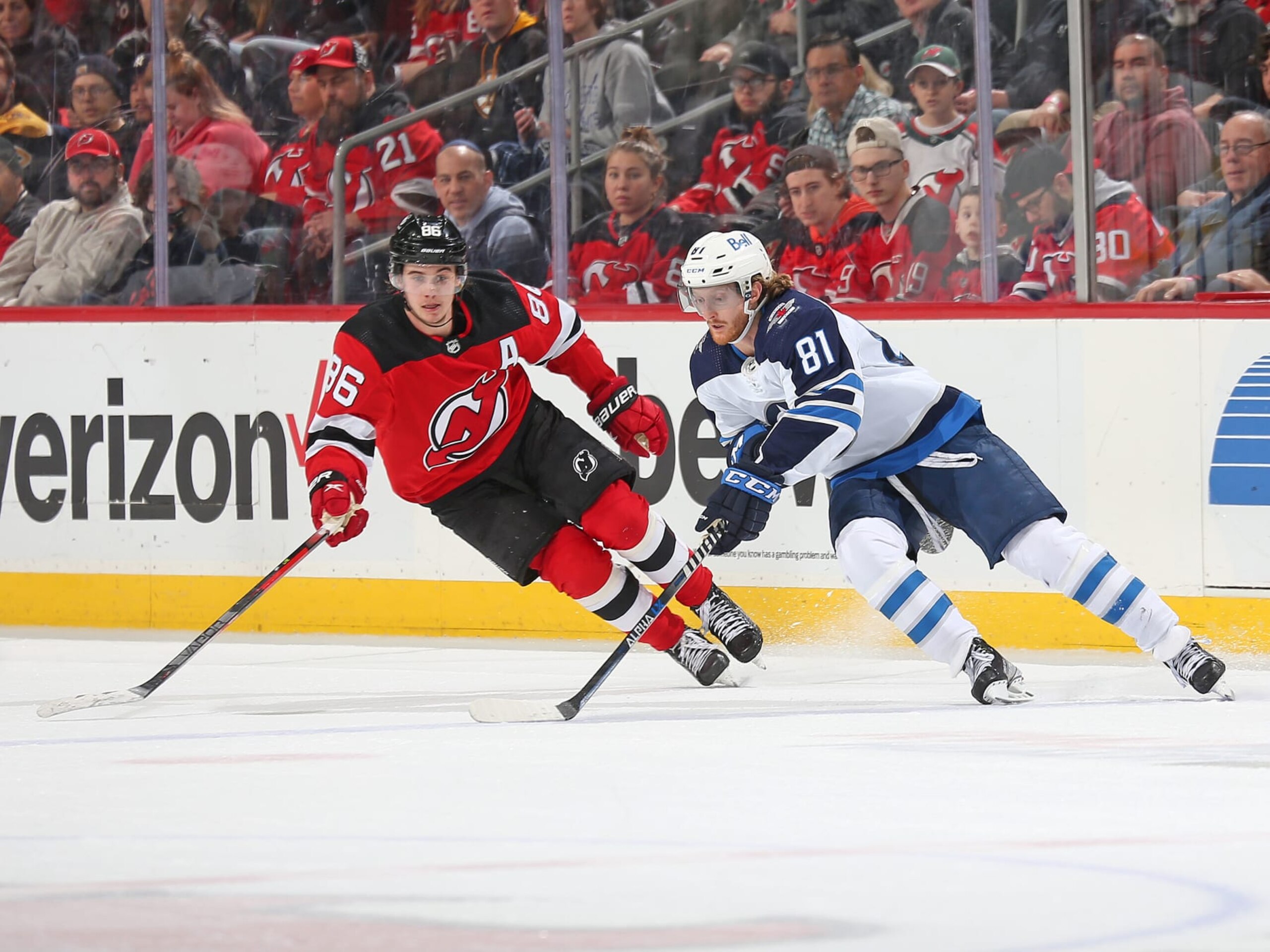 NEWARK, NJ - MARCH 10: Kyle Connor #81 of the Winnipeg Jets skates against Jack Hughes #86 of the New Jersey Devils during the third period  on March 10, 2022 at the Prudential Center in Newark, New Jersey. The Jets defeated the Devils 2-1. (Photo by Andy Marlin/NHLI via Getty Images)