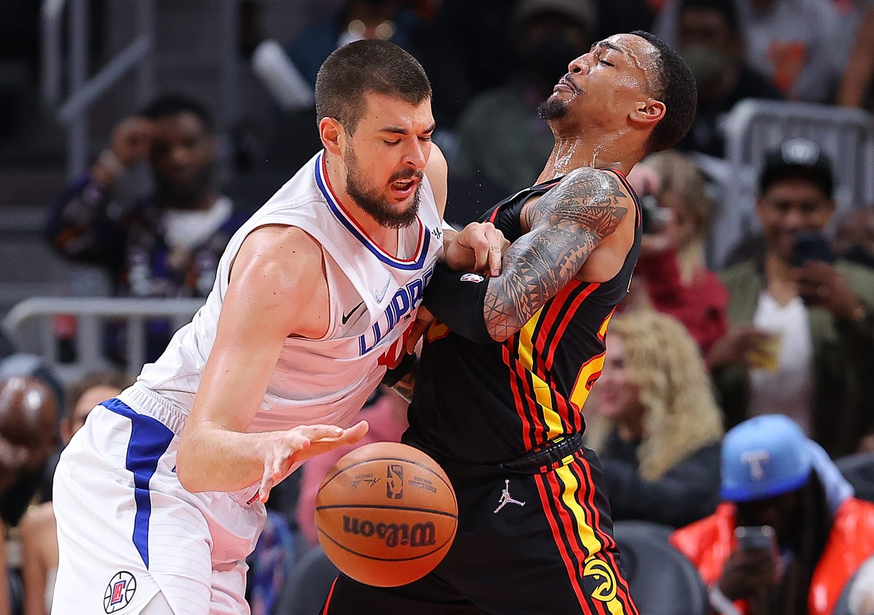 ATLANTA, GEORGIA - MARCH 11:  Ivica Zubac #40 of the Los Angeles Clippers drives against John Collins #20 of the Atlanta Hawks during the first half at State Farm Arena on March 11, 2022 in Atlanta, Georgia.  NOTE TO USER: User expressly acknowledges and agrees that, by downloading and or using this photograph, User is consenting to the terms and conditions of the Getty Images License Agreement. (Photo by Kevin C. Cox/Getty Images)