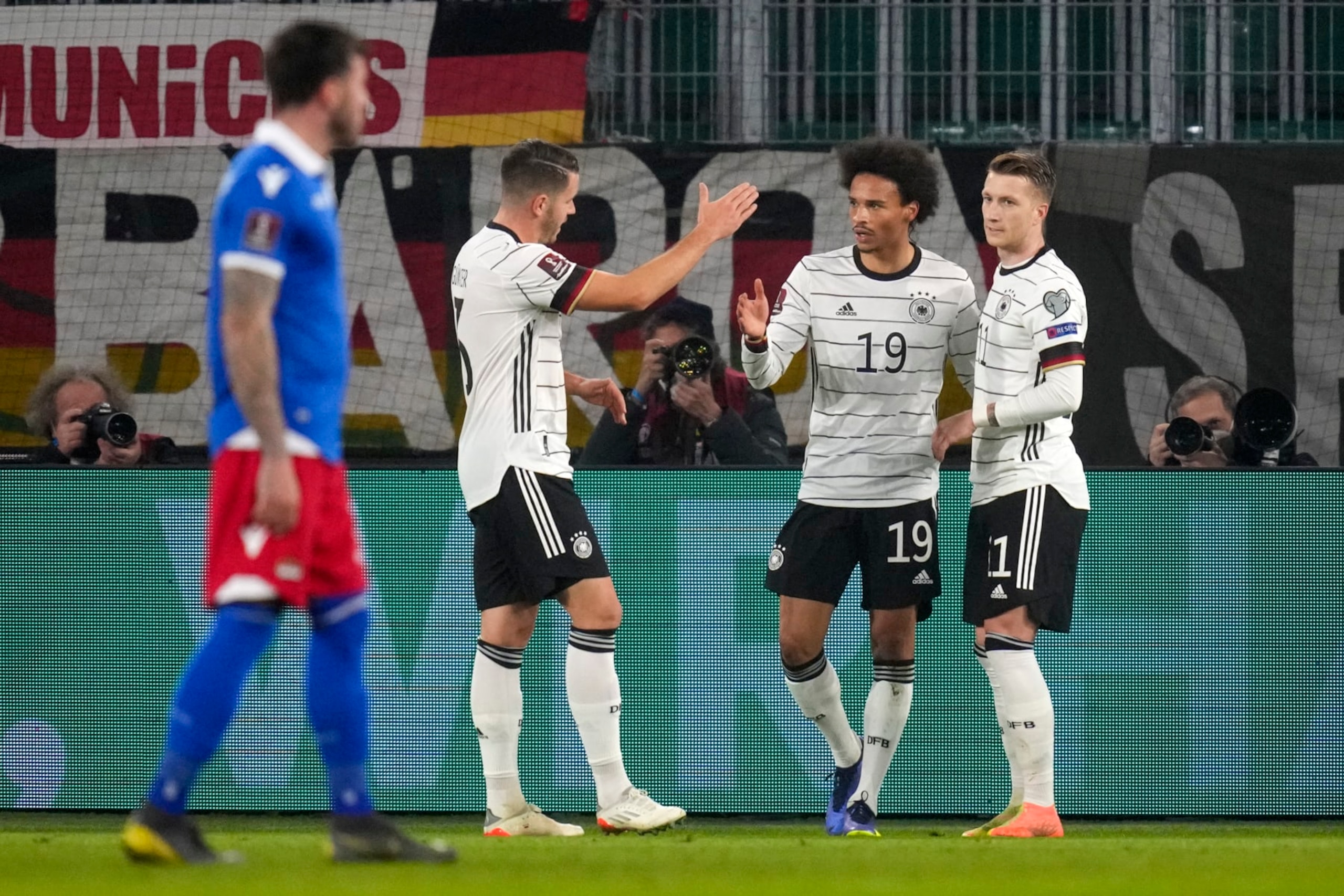 Germany's Leroy Sane, second right, is congratulated by teammates after scoring his team's third goal during the World Cup 2022 group J qualifying soccer match between Germany and Liechtenstein in Wolfsburg, Germany, Thursday, Nov. 11, 2021. (AP Photo/Michael Sohn)