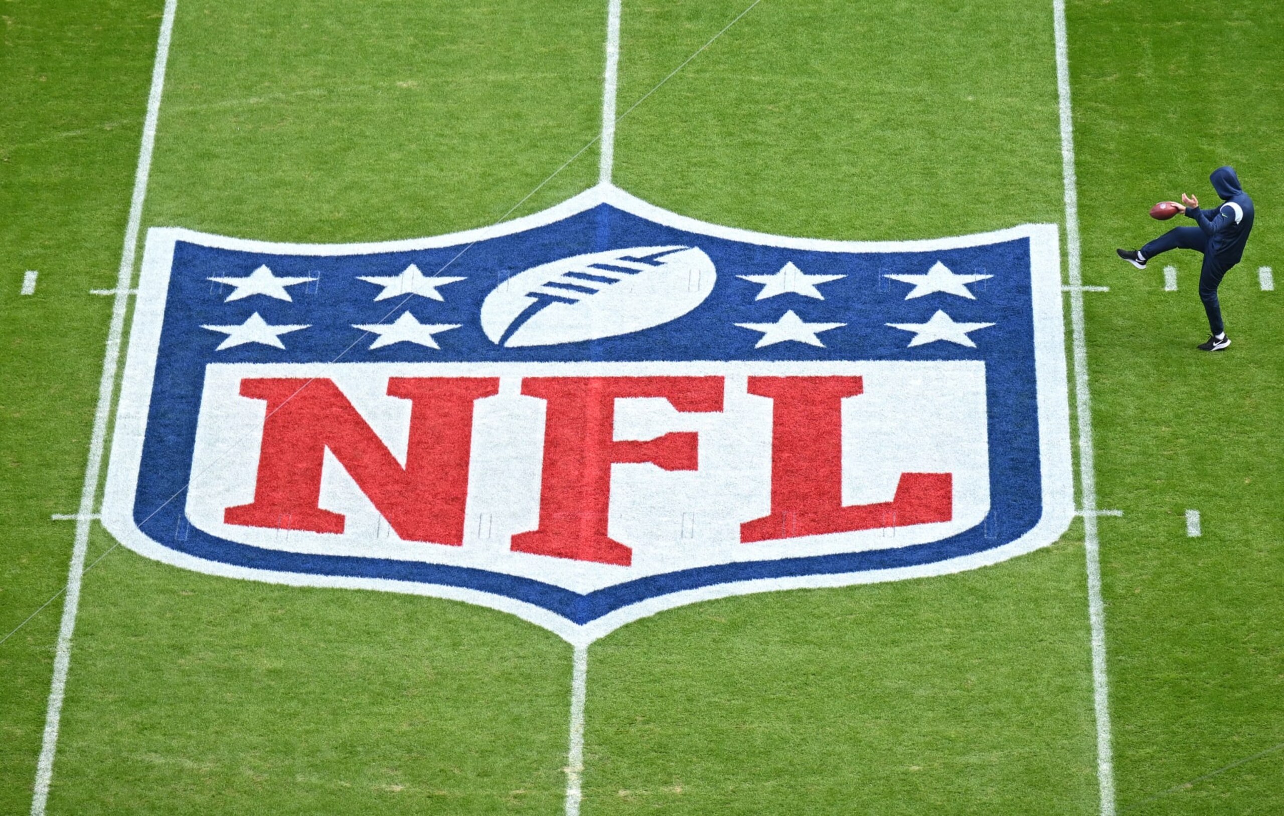 MUNICH, GERMANY - NOVEMBER 13: A player warms up next to the NFL logo painted on the field prior to the NFL match between Seattle Seahawks and Tampa Bay Buccaneers at Allianz Arena on November 13, 2022 in Munich, Germany. (Photo by Sebastian Widmann/Getty Images)