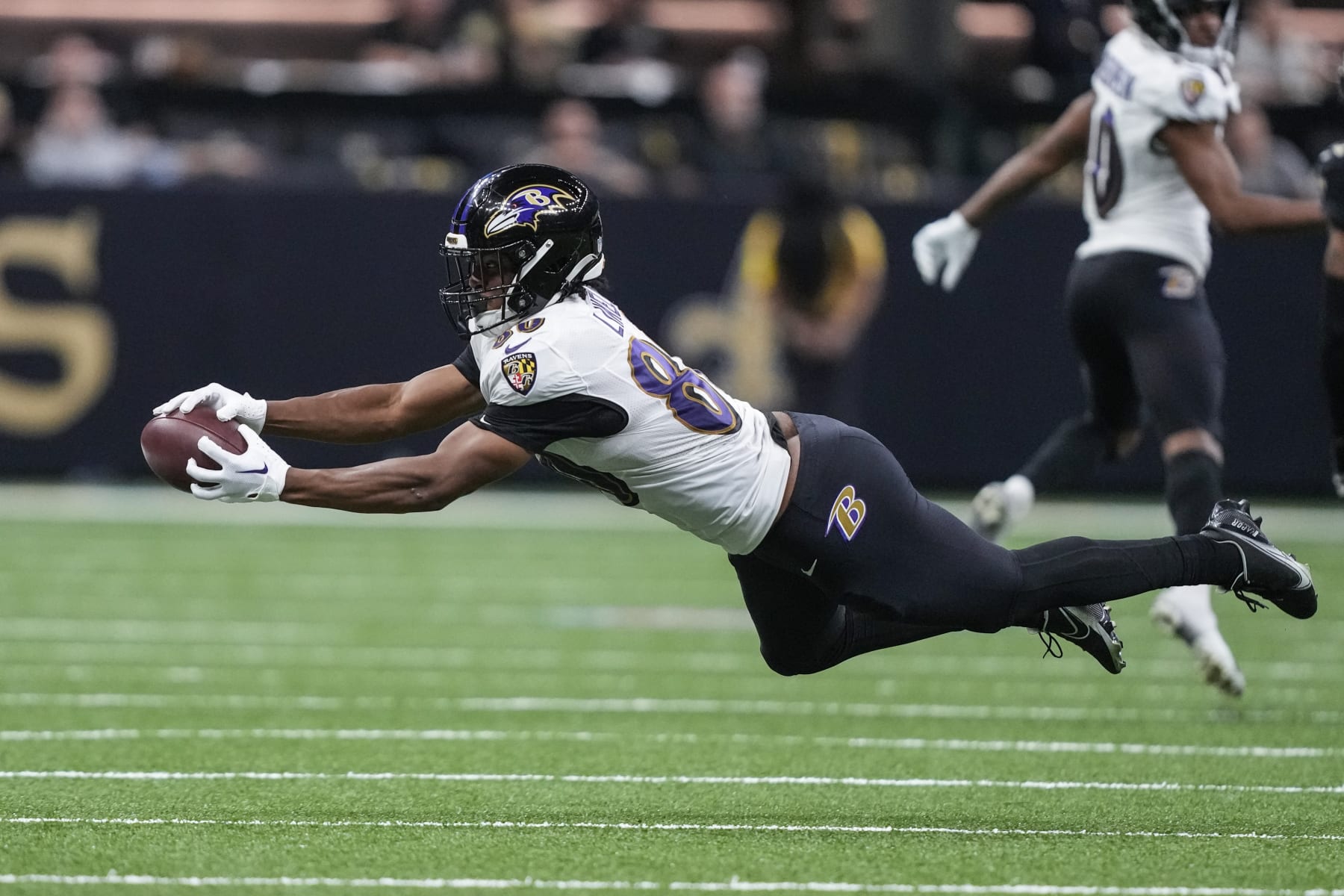 Baltimore Ravens tight end Isaiah Likely (80) extends but can't make the catch in the second half of an NFL football game against the New Orleans Saints in New Orleans, Monday, Nov. 7, 2022. (AP Photo/Gerald Herbert)