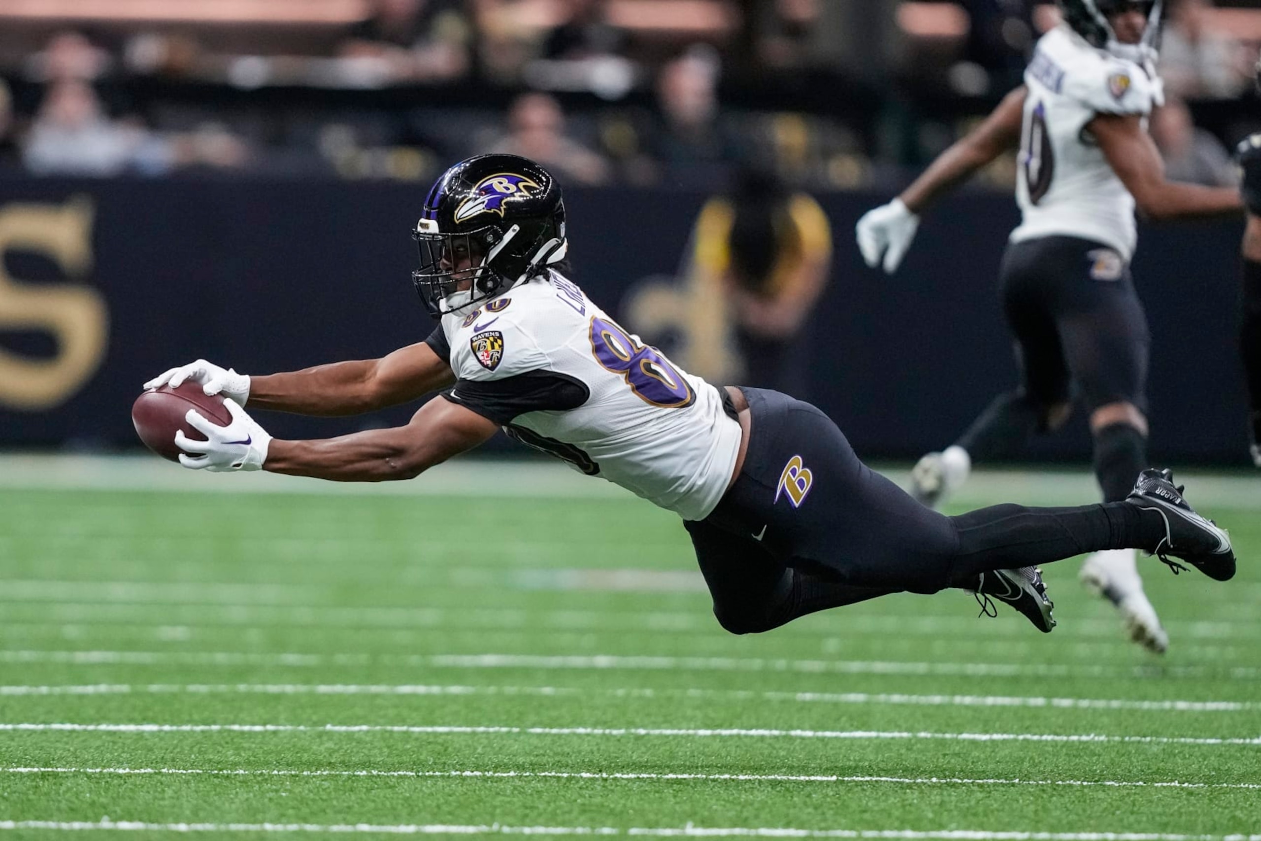 Baltimore Ravens tight end Isaiah Likely (80) extends but can't make the catch in the second half of an NFL football game against the New Orleans Saints in New Orleans, Monday, Nov. 7, 2022. (AP Photo/Gerald Herbert)
