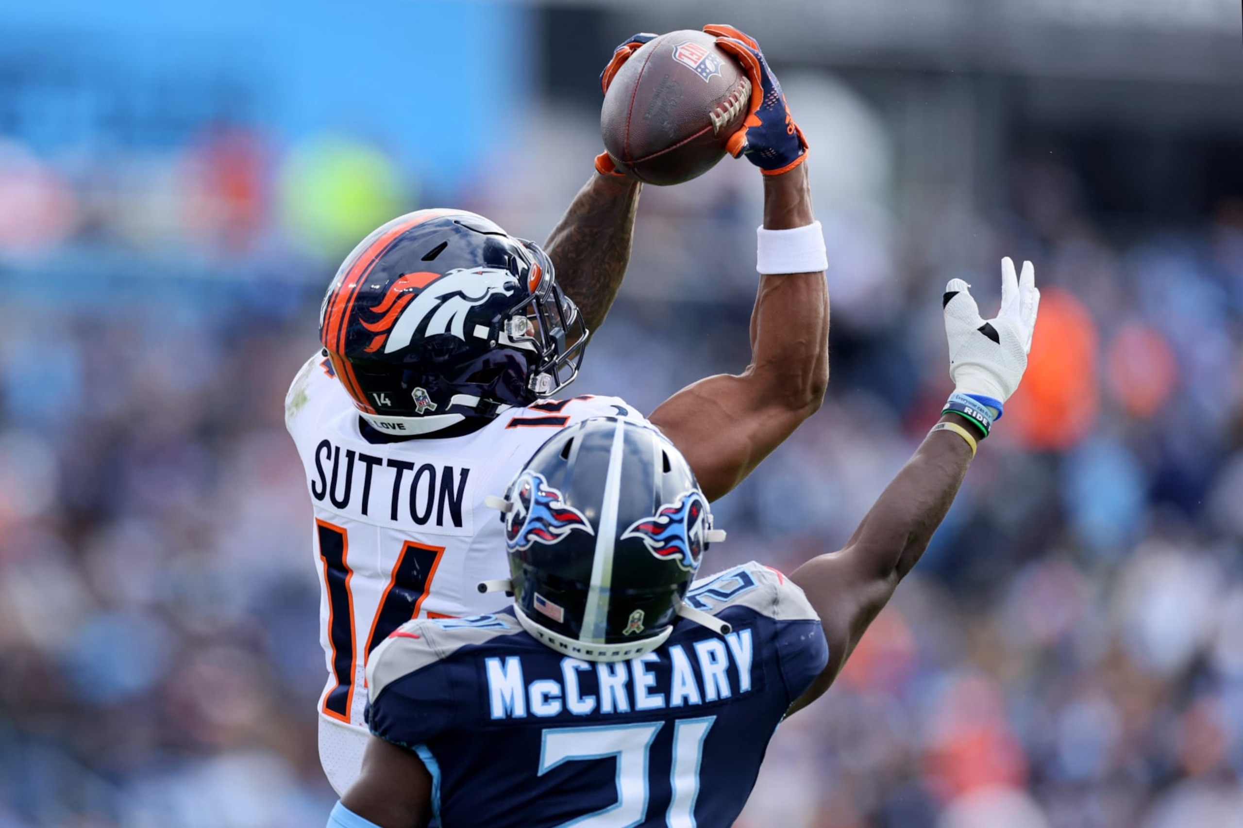 NASHVILLE, TENNESSEE - NOVEMBER 13: Courtland Sutton #14 of the Denver Broncos catches a pass over Roger McCreary #21 of the Tennessee Titans during the second quarter at Nissan Stadium on November 13, 2022 in Nashville, Tennessee. (Photo by Andy Lyons/Getty Images) NASHVILLE, TENNESSEE - NOVEMBER 13: Courtland Sutton #14 of the Denver Broncos catches a pass over Roger McCreary #21 of the Tennessee Titans during the second quarter at Nissan Stadium on November 13, 2022 in Nashville, Tennessee. (Photo by Andy Lyons/Getty Images)