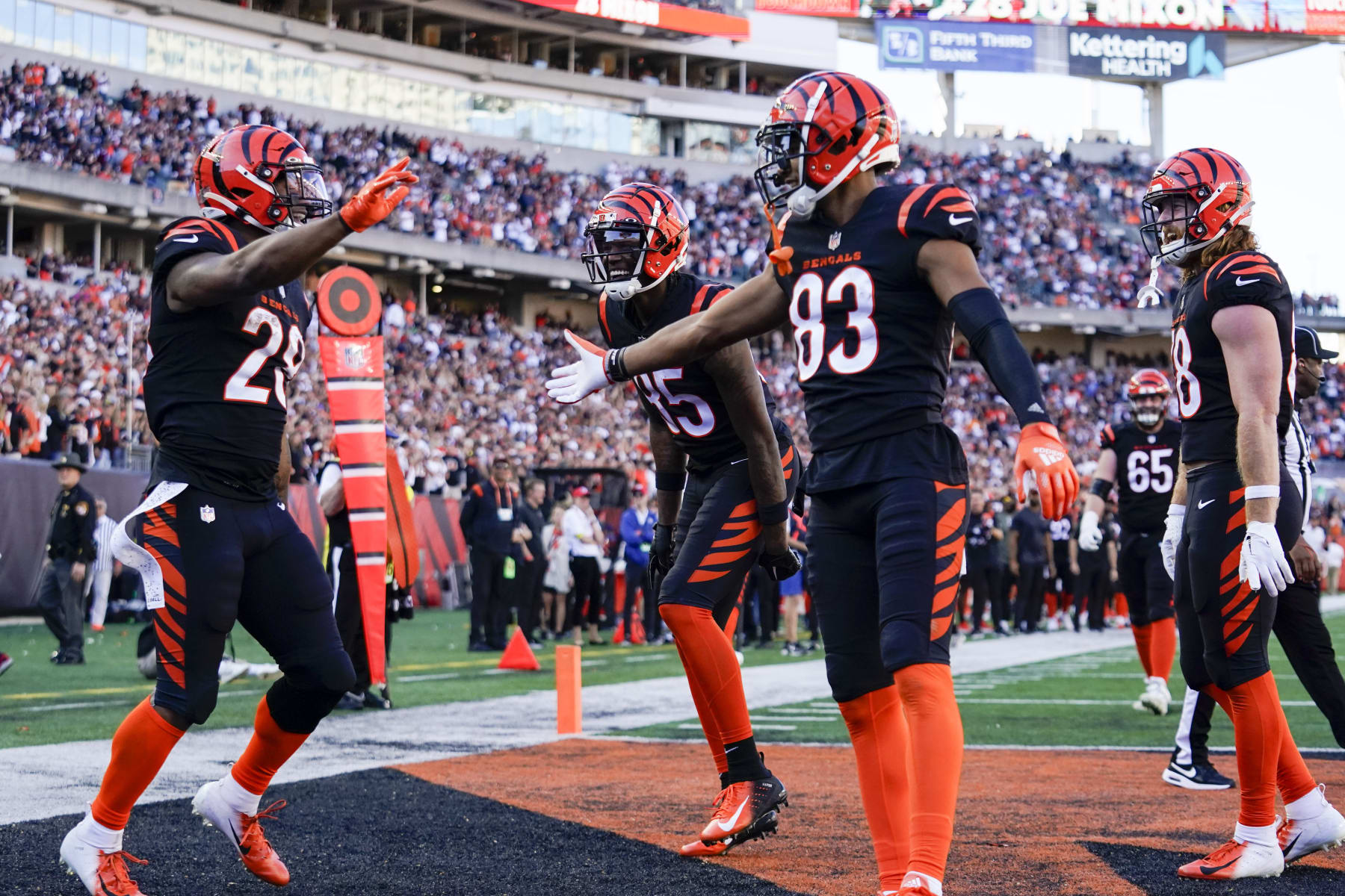Cincinnati Bengals running back Joe Mixon (28) celebrates with teammates Tyler Boyd (83) and Tee Higgins (85) after scoring a touchdown during an NFL football game against the Carolina Panthers, Sunday, Nov. 6, 2022, in Cincinnati. (AP Photo/Jeff Dean)