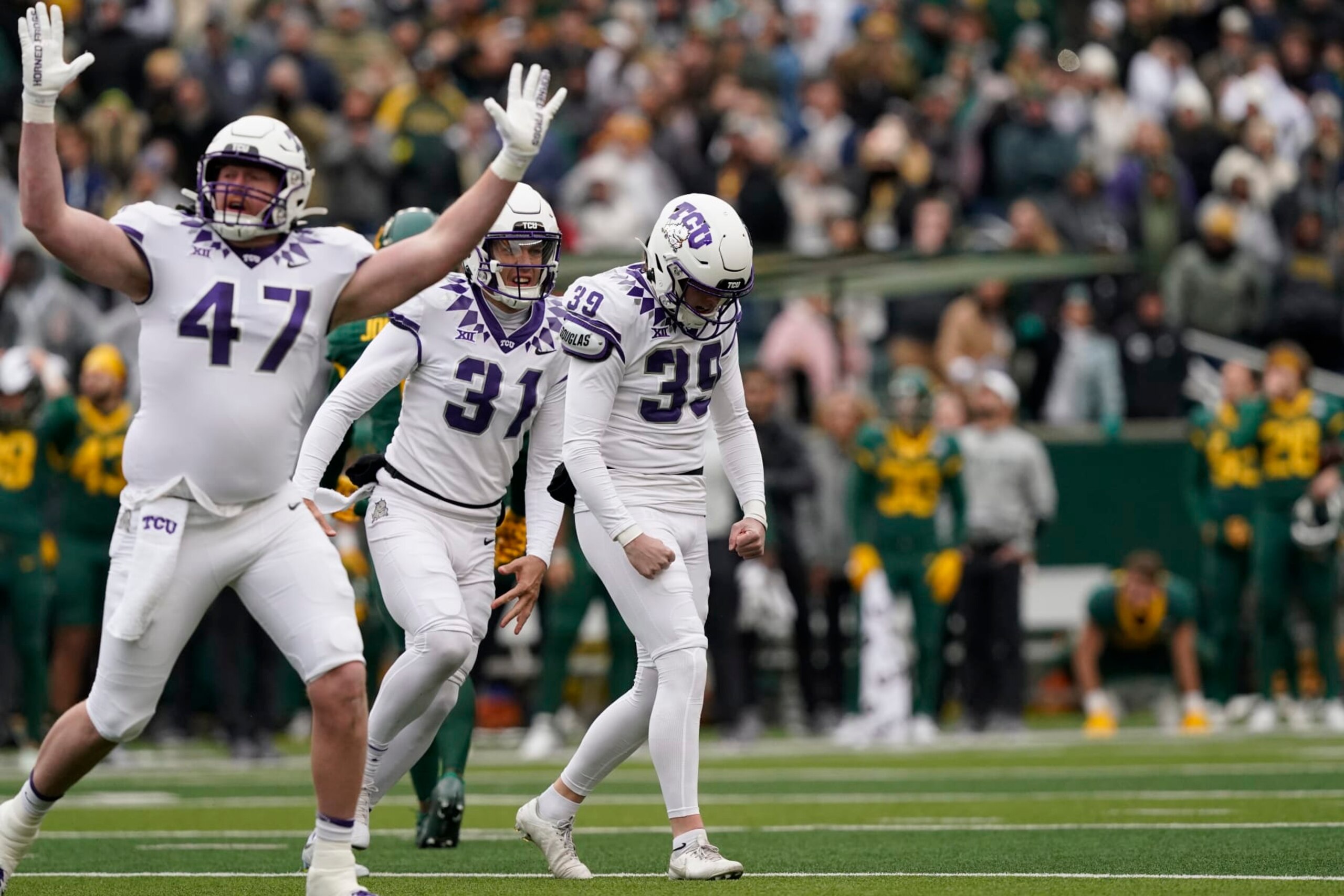 TCU place kicker Griffin Kell (39) celebrates with teammates Jake Boozer (47) and Jordy Sandy (31) after hitting a field goal in the final seconds of an NCAA college football game against Bayor in Waco, Texas, Saturday, Nov. 19, 2022. TCU won 29-28. (AP Photo/LM Otero) TCU place kicker Griffin Kell (39) celebrates with teammates Jake Boozer (47) and Jordy Sandy (31) after hitting a field goal in the final seconds of an NCAA college football game against Bayor in Waco, Texas, Saturday, Nov. 19, 2022. TCU won 29-28. (AP Photo/LM Otero)