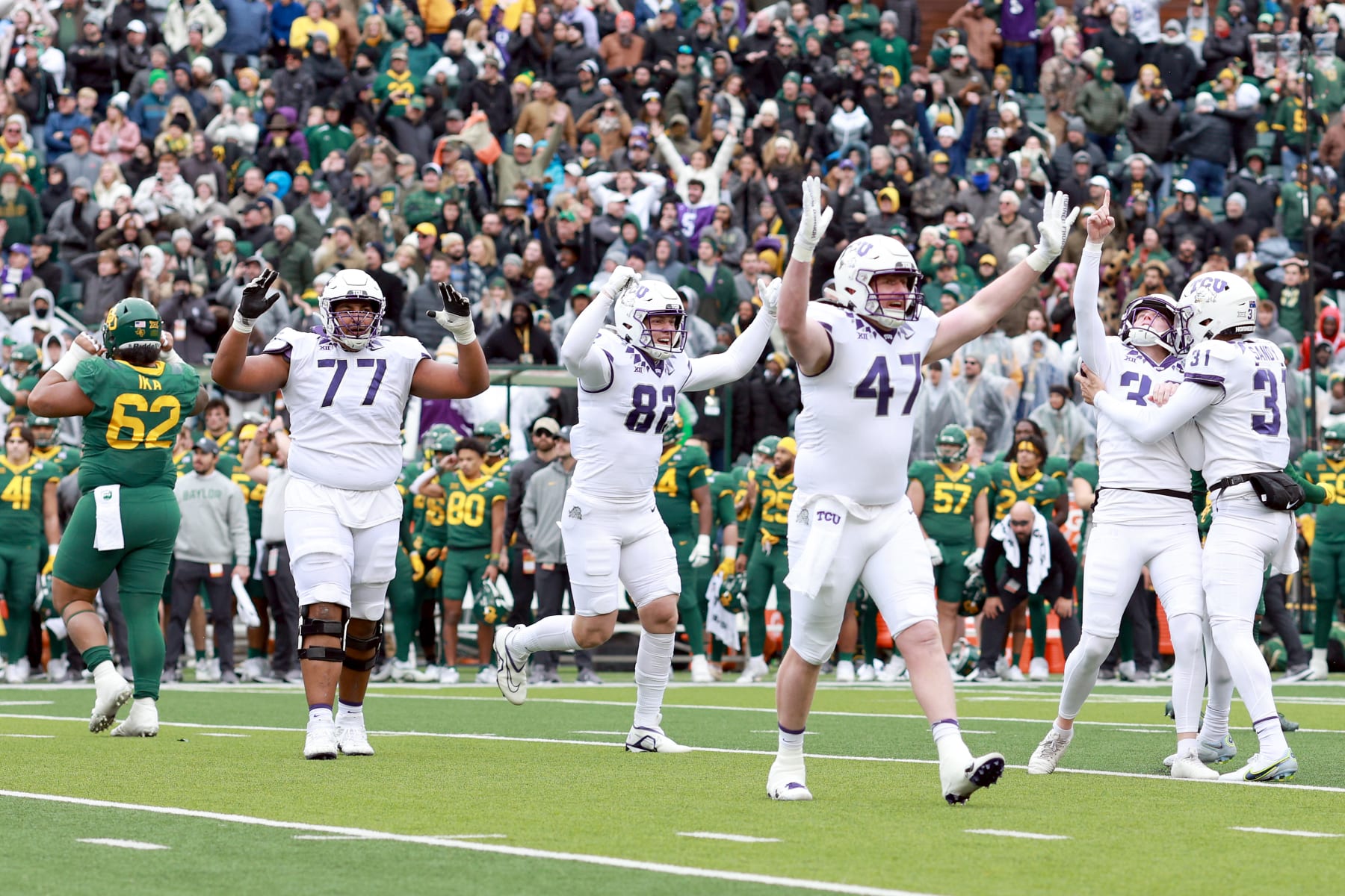 WACO, TEXAS - NOVEMBER 19: Place kicker Griffin Kell #39 of the TCU Horned Frogs celebrates with punter Jordy Sandy #31, offensive tackle Brandon Coleman #77, tight end Alex Honig #82 and tight end Carter Ware #47 of the TCU Horned Frogs after kicking the game-winning field goal in the final seconds against Baylor Bears at McLane Stadium on November 19, 2022 in Waco, Texas. (Photo by Tom Pennington/Getty Images)
