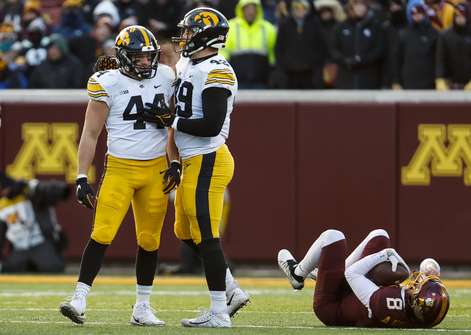 MINNEAPOLIS, MN - NOVEMBER 19: Seth Benson #44 of the Iowa Hawkeyes celebrates his tackle against Athan Kaliakmanis #8 of the Minnesota Golden Gophers with teammate Ethan Hurkett #49 in the second quarter of the game at Huntington Bank Stadium on November 19, 2022 in Minneapolis, Minnesota. (Photo by David Berding/Getty Images)