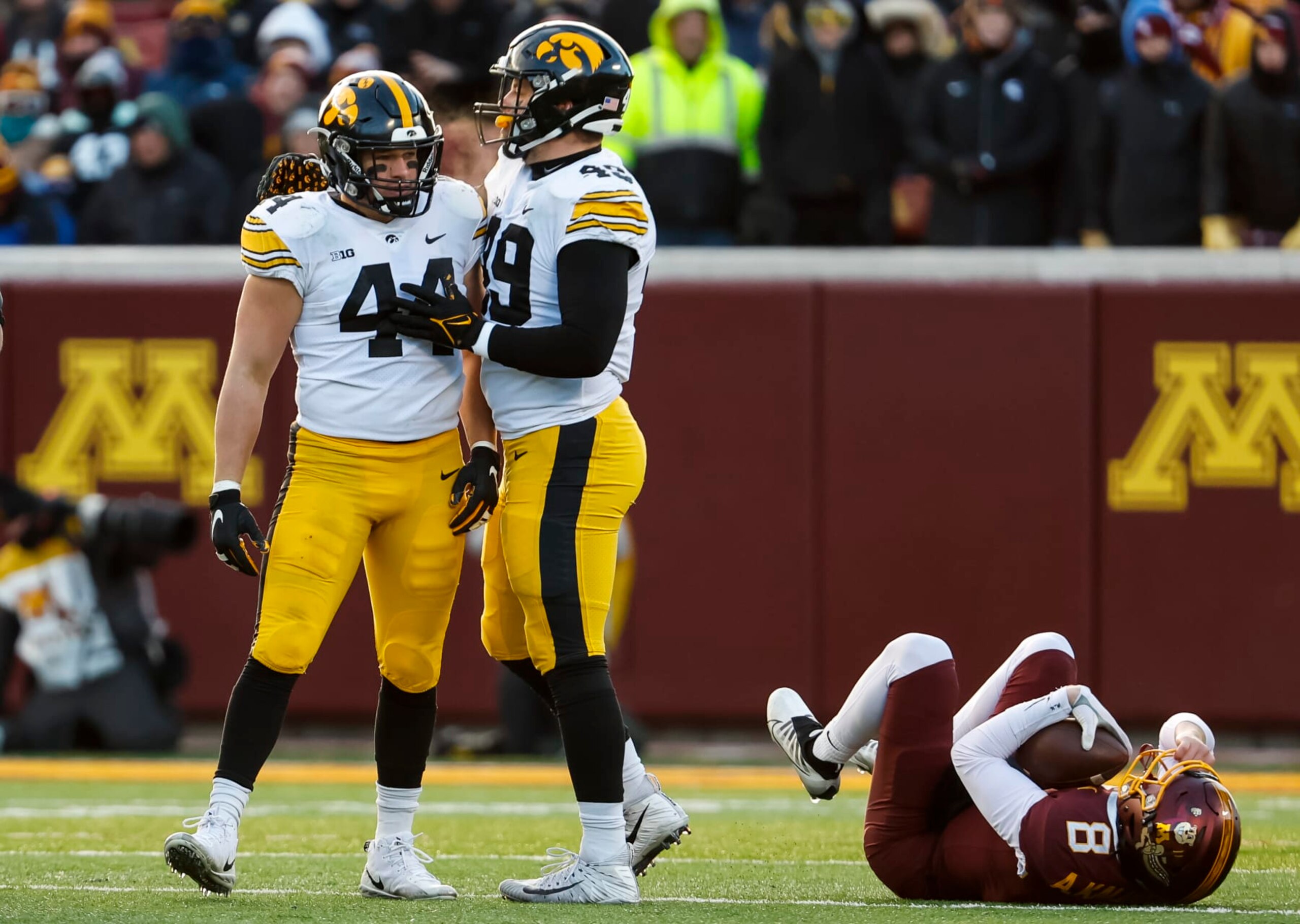 MINNEAPOLIS, MN - NOVEMBER 19: Seth Benson #44 of the Iowa Hawkeyes celebrates his tackle against Athan Kaliakmanis #8 of the Minnesota Golden Gophers with teammate Ethan Hurkett #49 in the second quarter of the game at Huntington Bank Stadium on November 19, 2022 in Minneapolis, Minnesota. (Photo by David Berding/Getty Images) MINNEAPOLIS, MN - NOVEMBER 19: Seth Benson #44 of the Iowa Hawkeyes celebrates his tackle against Athan Kaliakmanis #8 of the Minnesota Golden Gophers with teammate Ethan Hurkett #49 in the second quarter of the game at Huntington Bank Stadium on November 19, 2022 in Minneapolis, Minnesota. (Photo by David Berding/Getty Images)