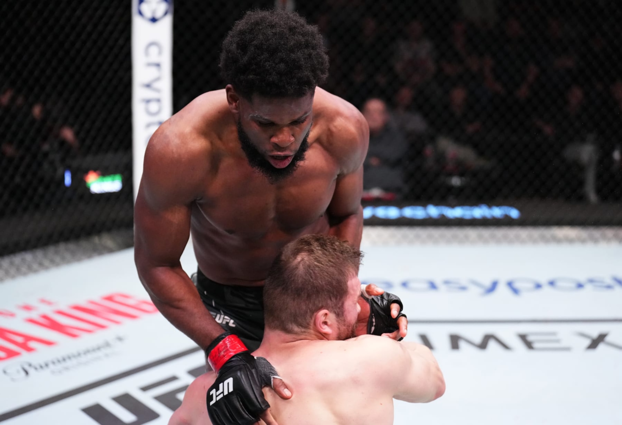 LAS VEGAS, NEVADA - NOVEMBER 19: (R-L) Kennedy Nzechukwu of Nigeria drops Ion Cutelaba of Moldova with a flying knee in a light heavyweight fight during the UFC Fight Night event at UFC APEX on November 19, 2022 in Las Vegas, Nevada. (Photo by Chris Unger/Zuffa LLC)