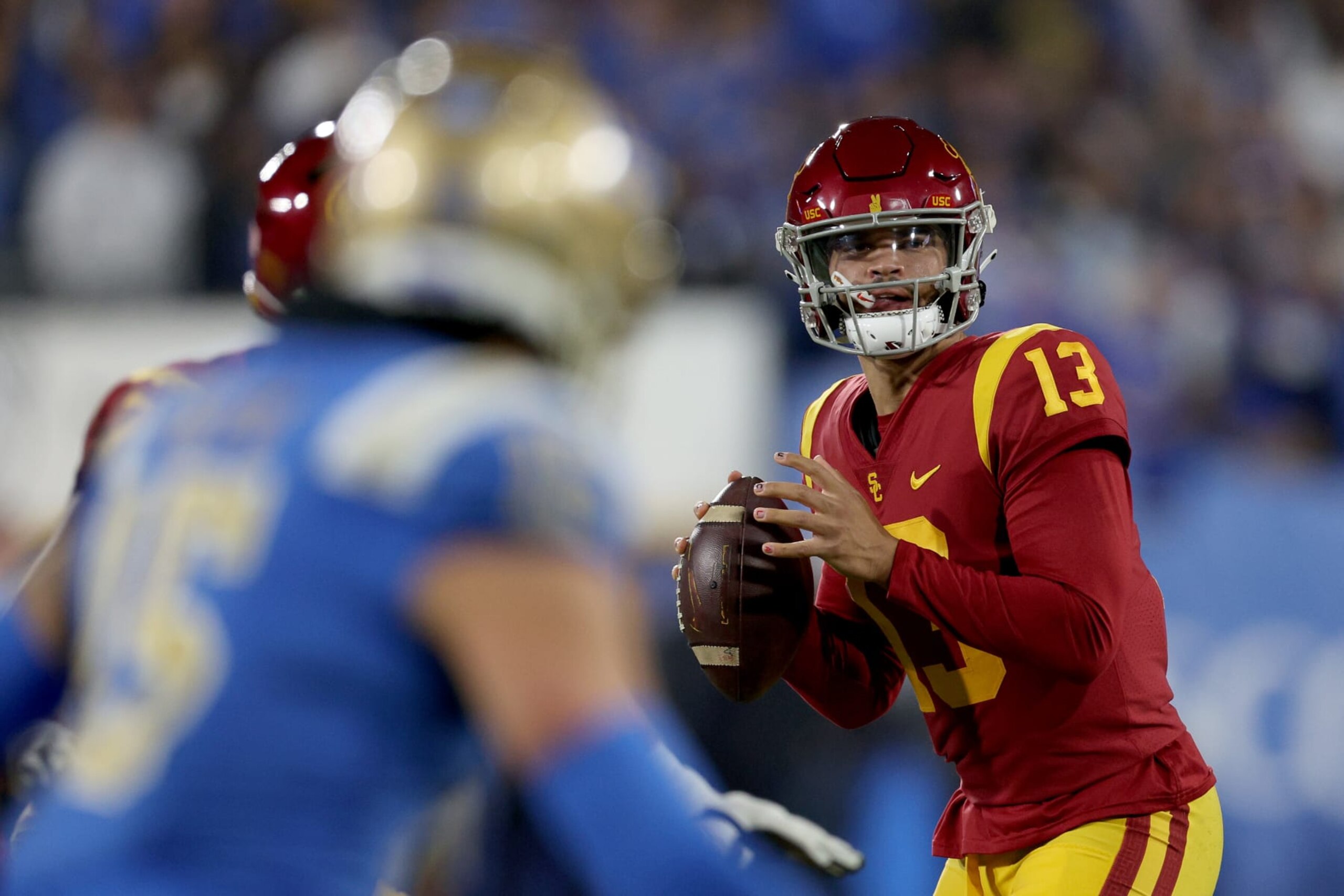 PASADENA, CALIFORNIA - NOVEMBER 19: Caleb Williams #13 of the USC Trojans looks to pass against the UCLA Bruins during the first quarter in the game at Rose Bowl on November 19, 2022 in Pasadena, California. (Photo by Harry How/Getty Images)