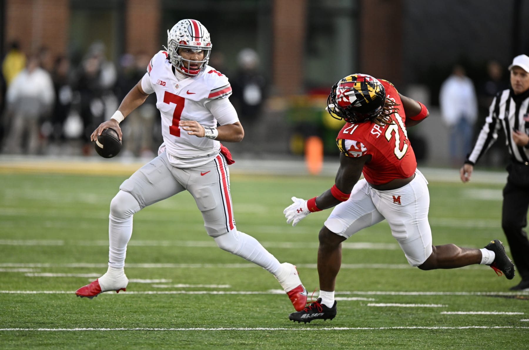 COLLEGE PARK, MARYLAND - NOVEMBER 19: C.J. Stroud #7 of the Ohio State Buckeyes rolls out of the pocket against Gereme Spraggins #21 of the Maryland Terrapins in the second quarter at SECU Stadium on November 19, 2022 in College Park, Maryland. (Photo by Greg Fiume/Getty Images)