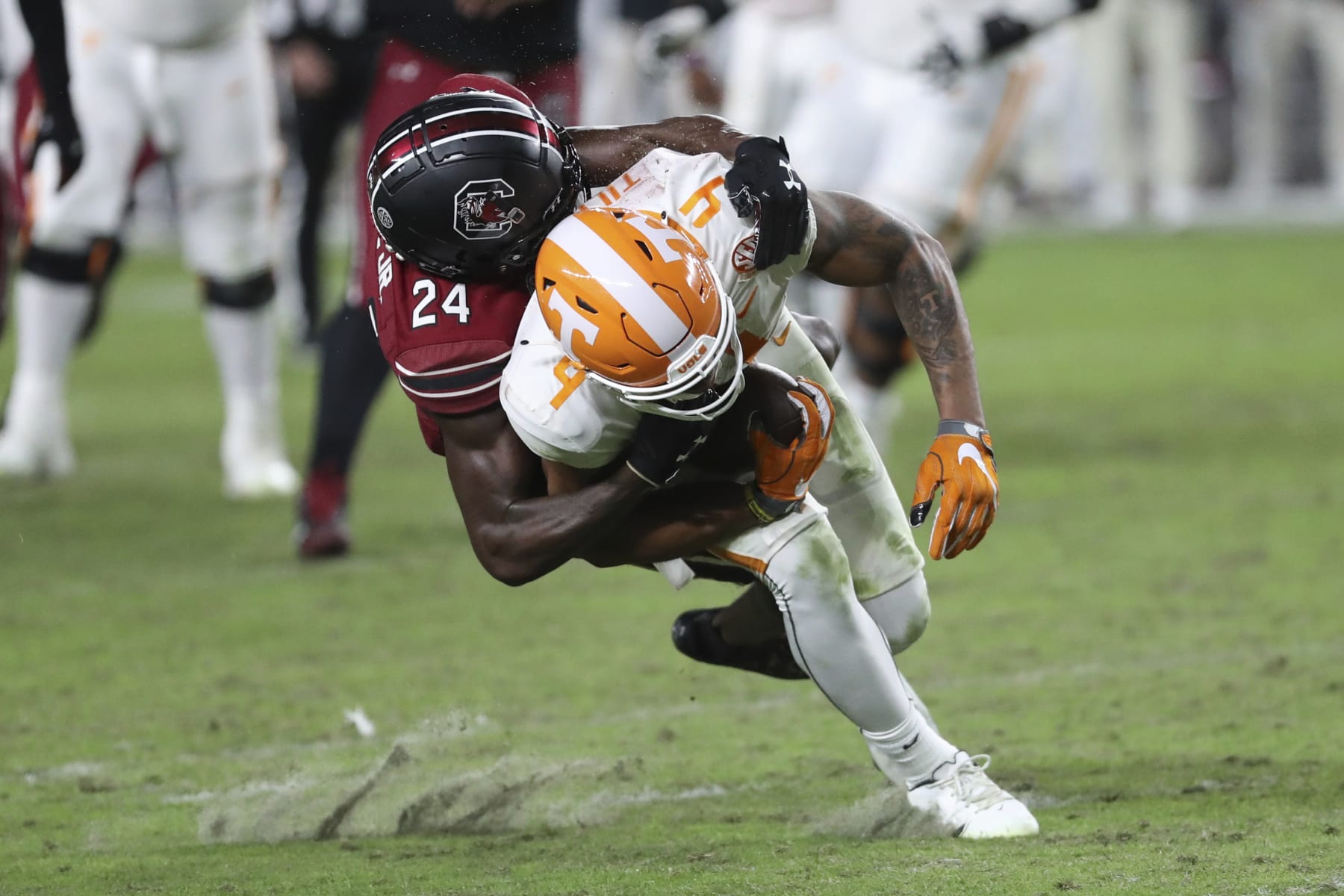 South Carolina defensive back Marcellas Dial Jr. (24) tackles Tennessee wide receiver Cedric Tillman (4) after a catch during the second half of an NCAA college football game Saturday, Nov. 19, 2022, in Columbia, S.C. (AP Photo/Artie Walker Jr.)