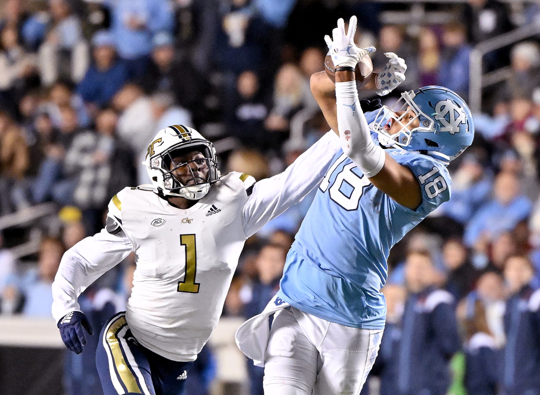 CHAPEL HILL, NORTH CAROLINA - NOVEMBER 19: Charlie Thomas #1 of the Georgia Tech Yellow Jackets defends a pass to Bryson Nesbit #18 of the North Carolina Tar Heels during the second half of their game at Kenan Memorial Stadium on November 19, 2022 in Chapel Hill, North Carolina. (Photo by Grant Halverson/Getty Images)