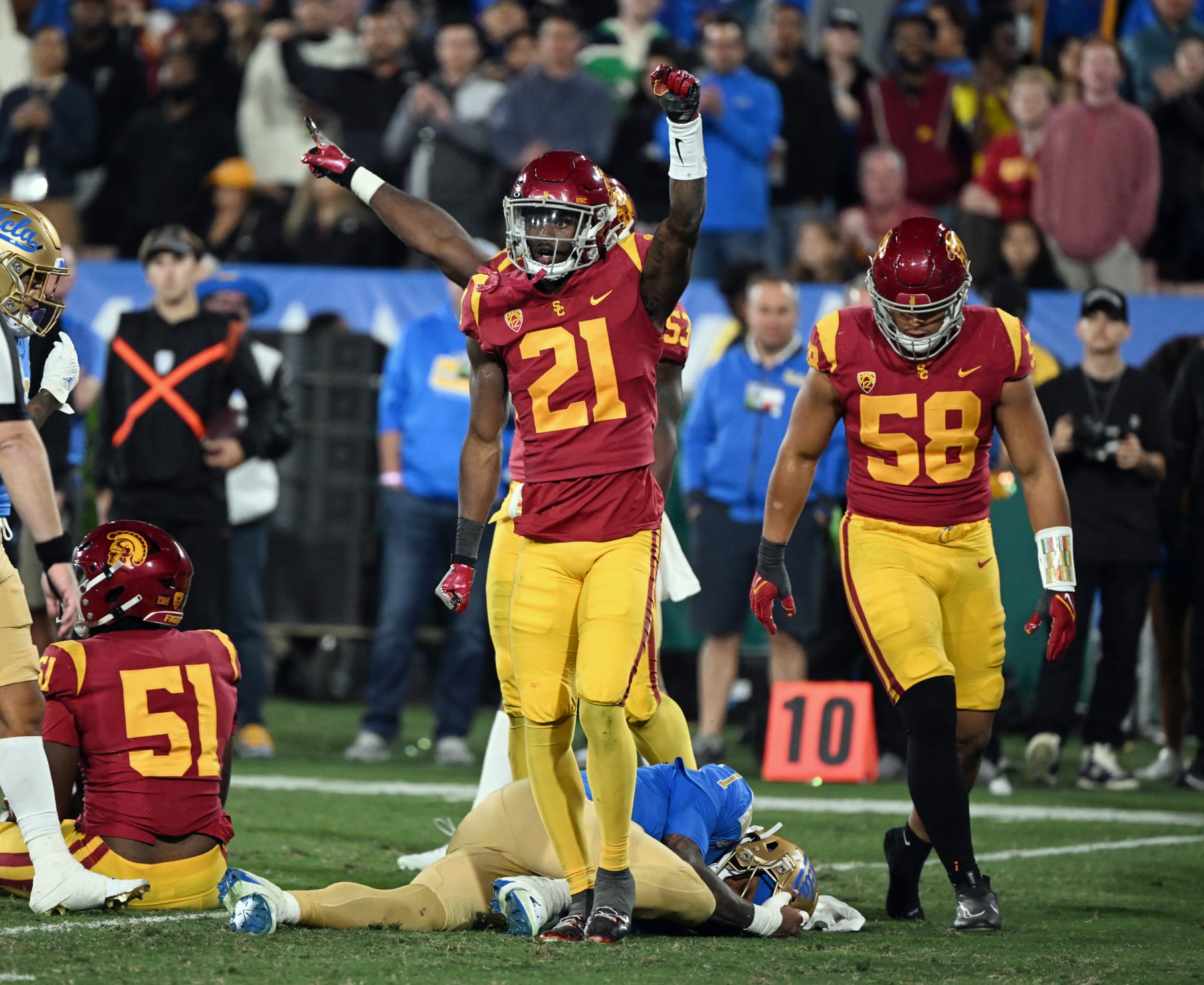 PASADENA, CA - NOVEMBER 19: USC Trojans defensive back Latrell McCutchin (21) reacts after hitting and stopping UCLA Bruins quarterback Dorian Thompson-Robinson (1) lying on the field during a college football game against the Trojans played on November 19, 2022 at the Rose Bowl in Pasadena, CA. (Photo by John Cordes/Icon Sportswire via Getty Images)